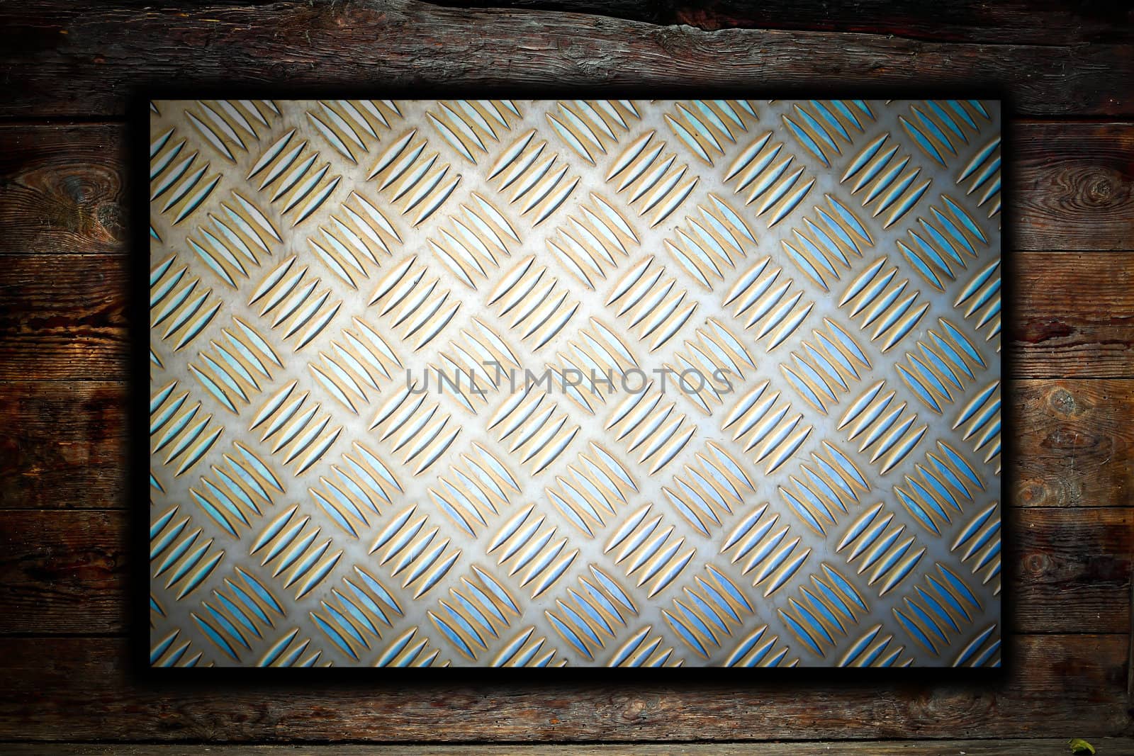 Metal plate on wooden background