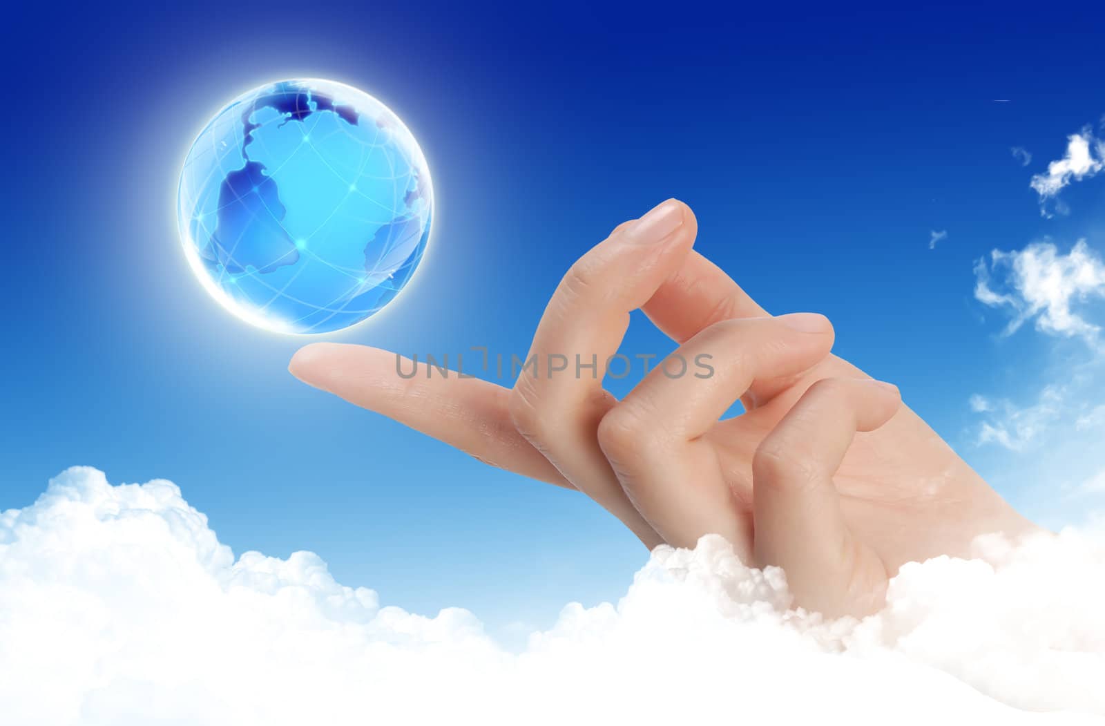 Globe in human hand against sun and blue sky by rufous