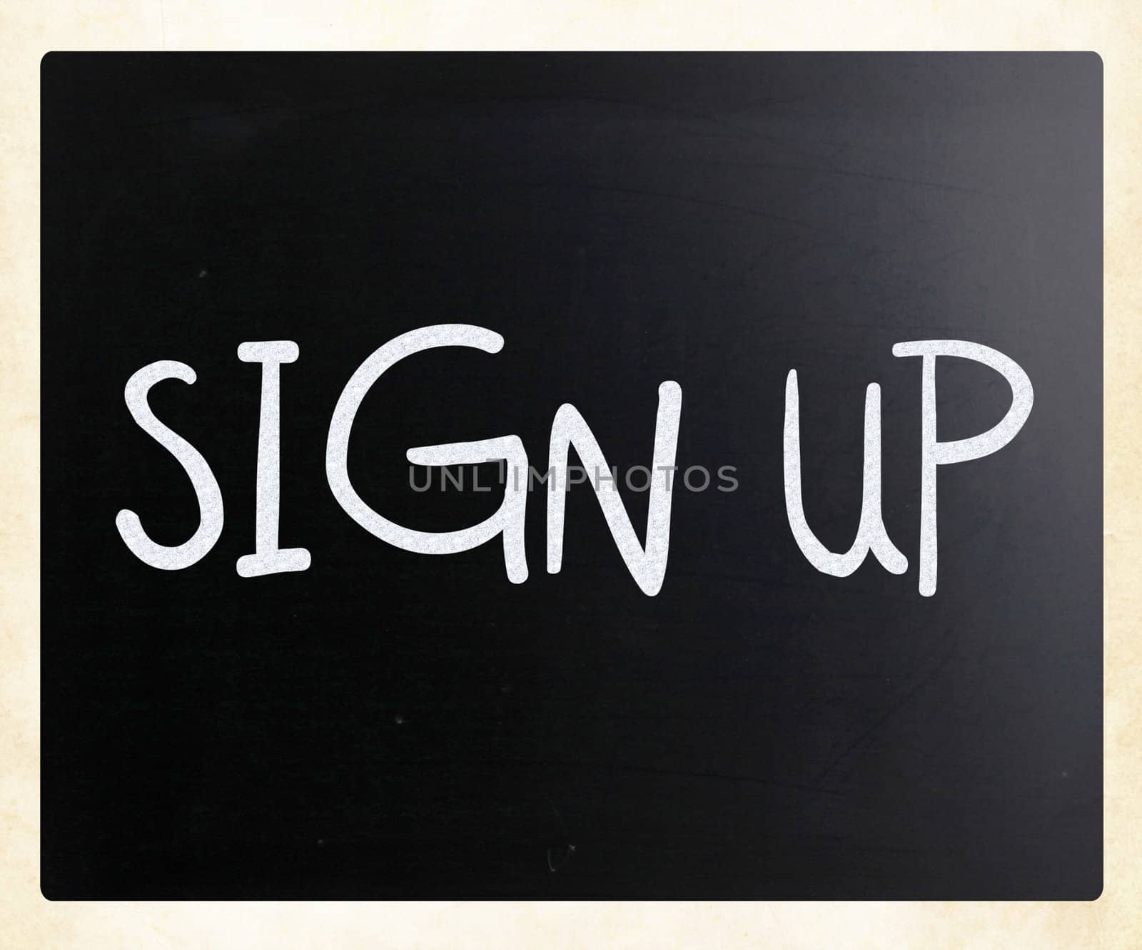 "Sign up" handwritten with white chalk on a blackboard