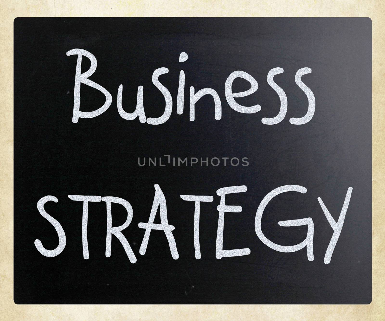 "Business strategy" handwritten with white chalk on a blackboard