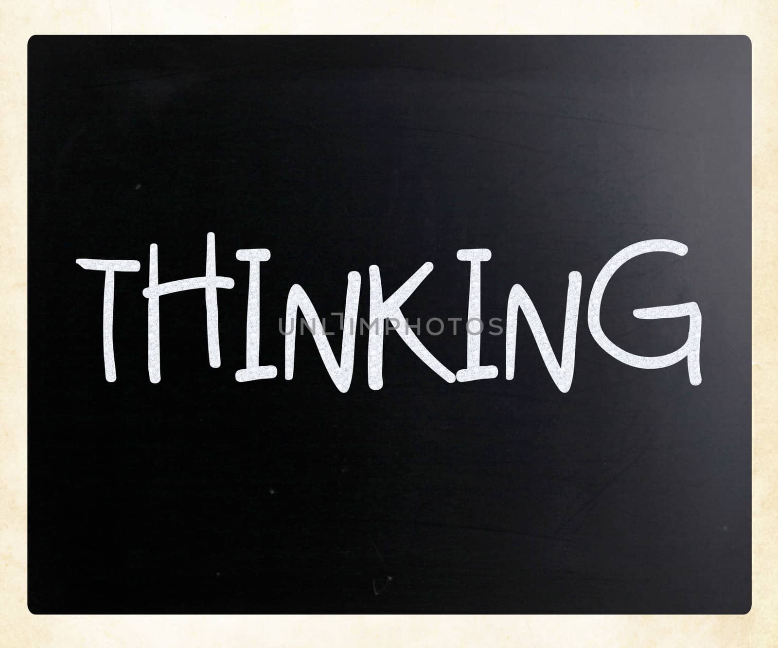 "Thinking" handwritten with white chalk on a blackboard