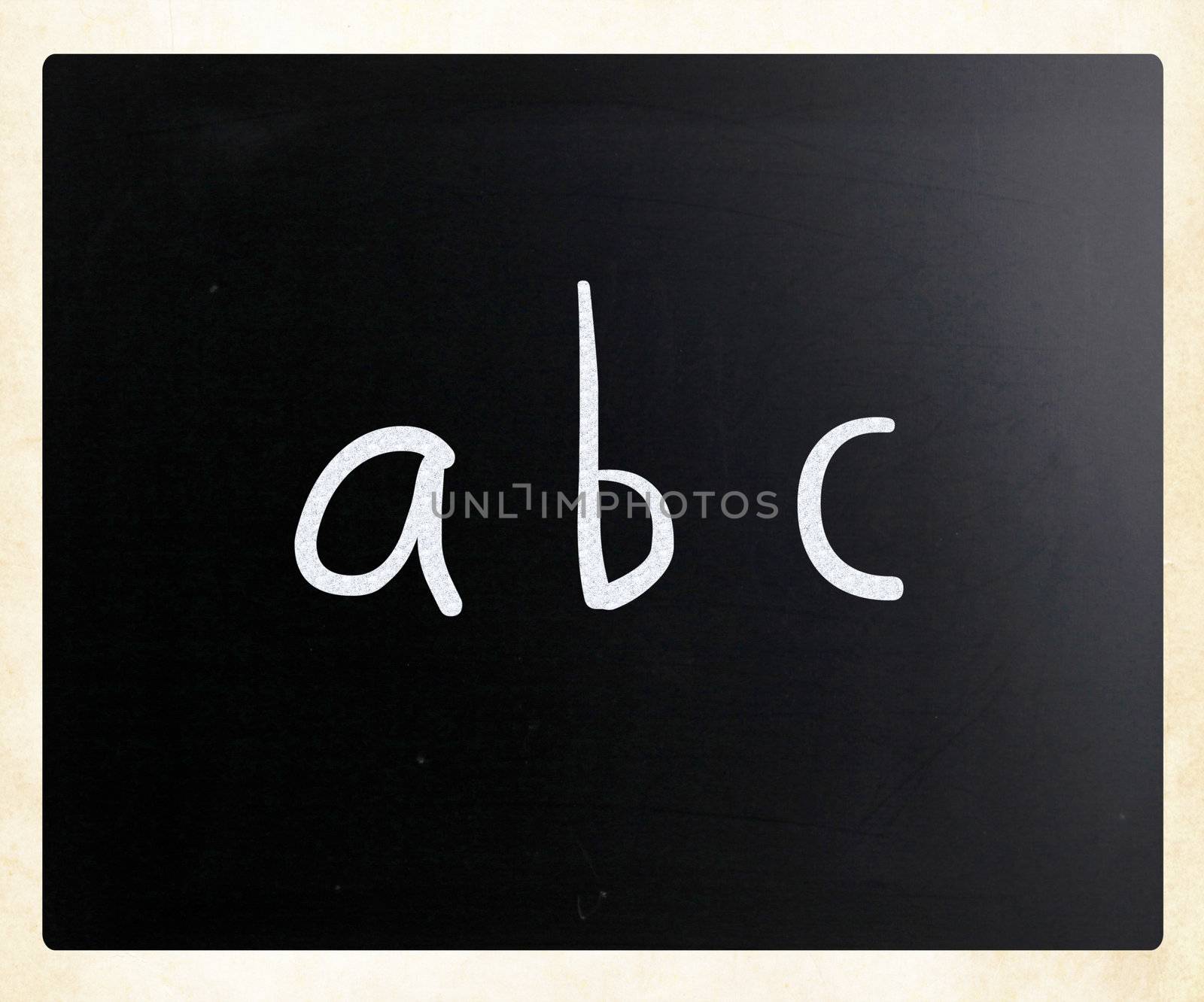"abc" handwritten with white chalk on a blackboard