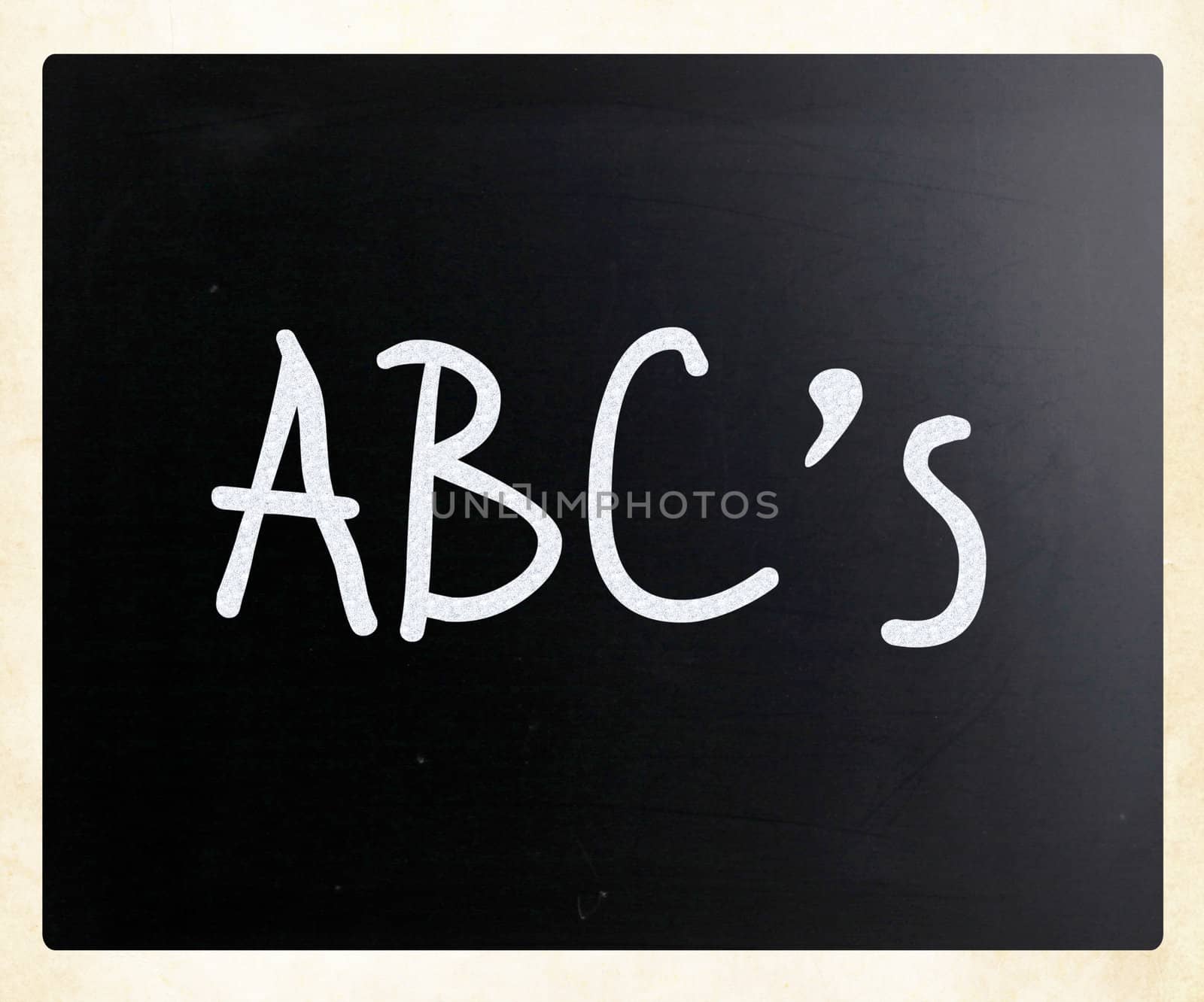 "ABC's" handwritten with white chalk on a blackboard