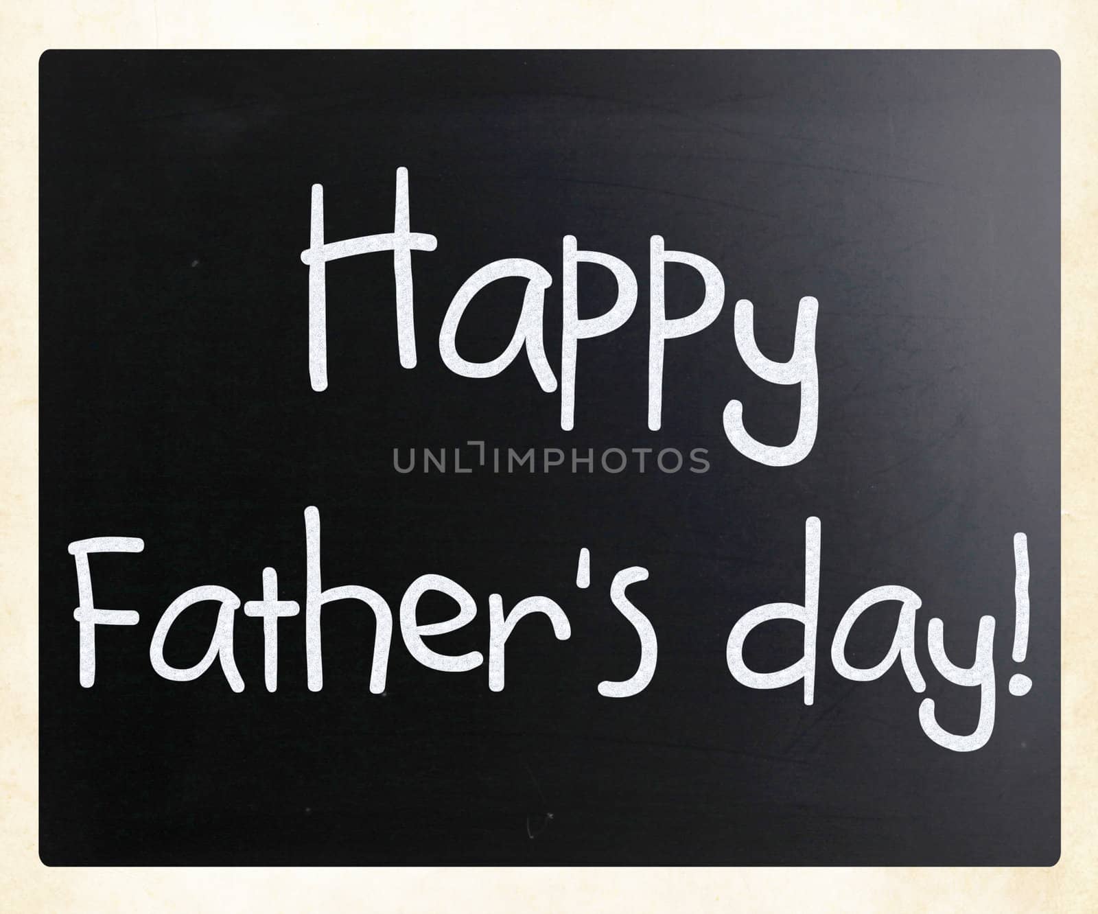 "Happy father's day" handwritten with white chalk on a blackboard