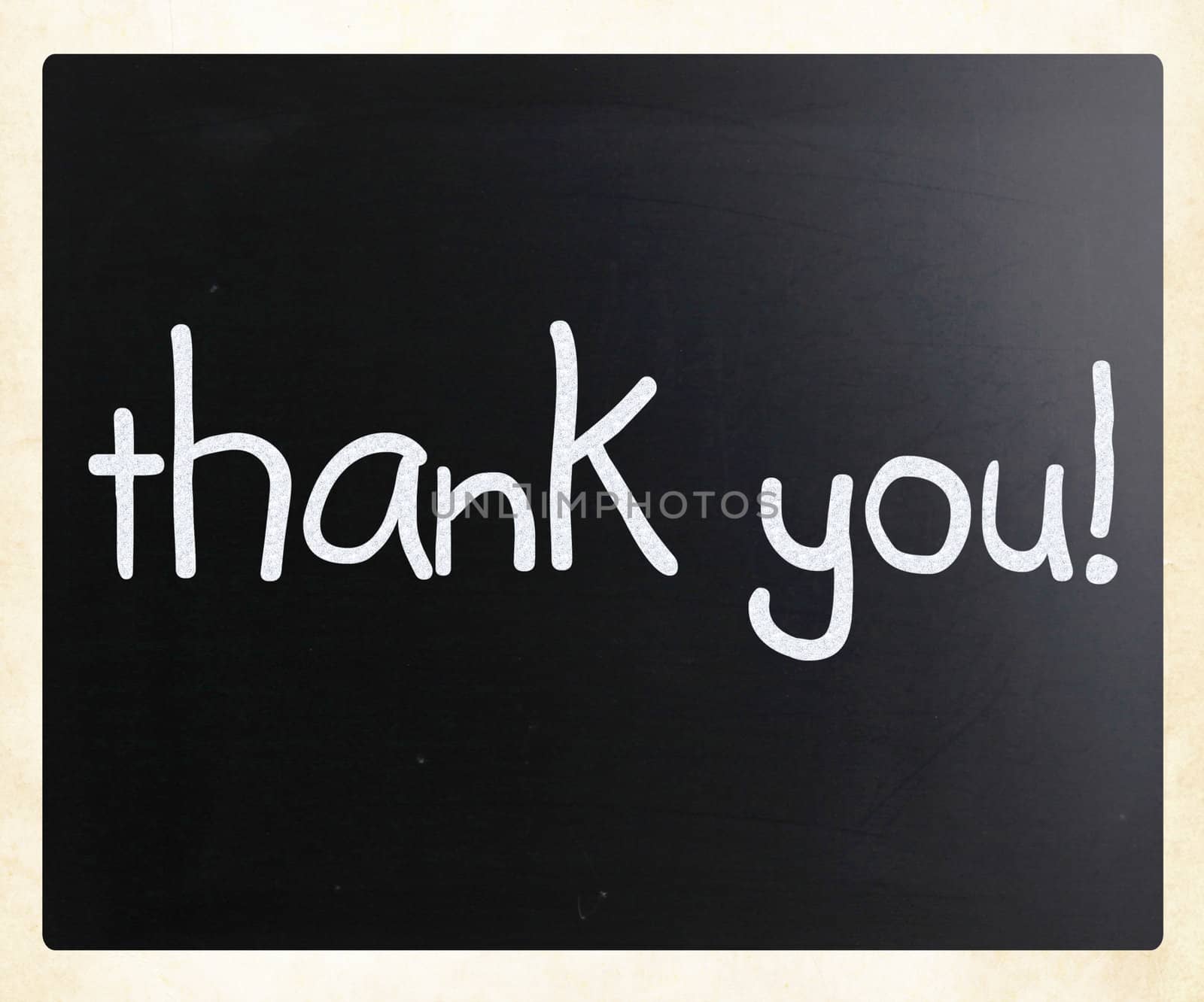 "Thank you" handwritten with white chalk on a blackboard