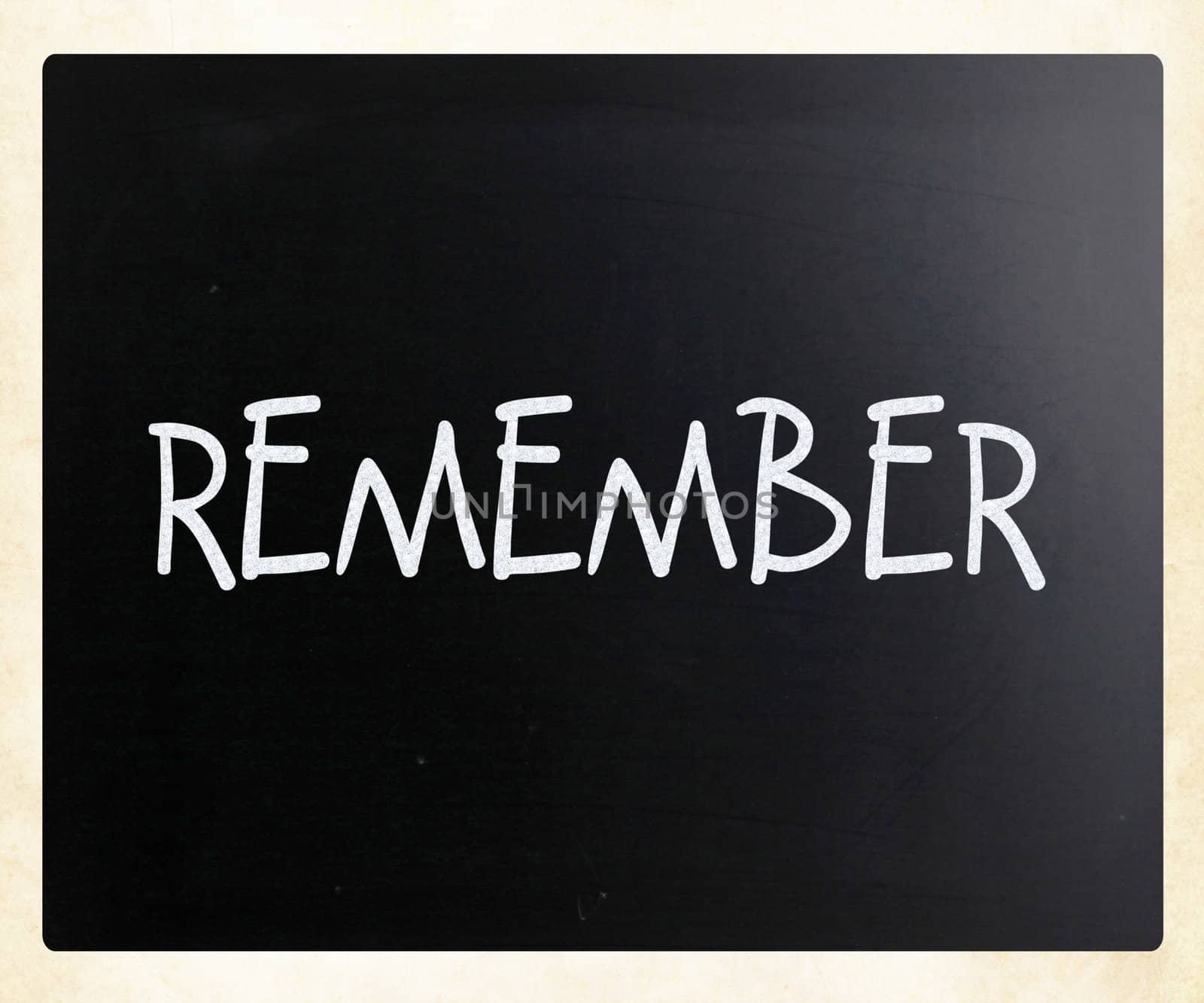 "Remember" handwritten with white chalk on a blackboard