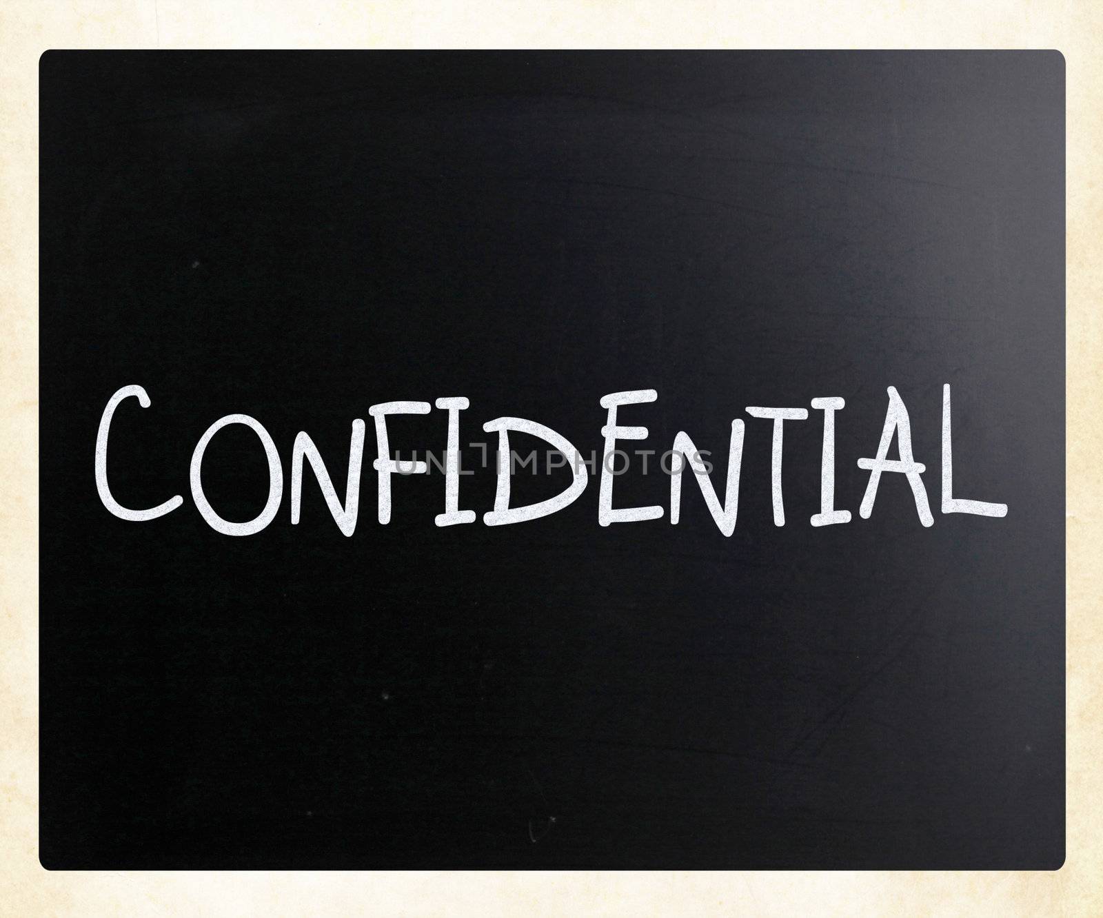 The word "Confidential" handwritten with white chalk on a blackboard