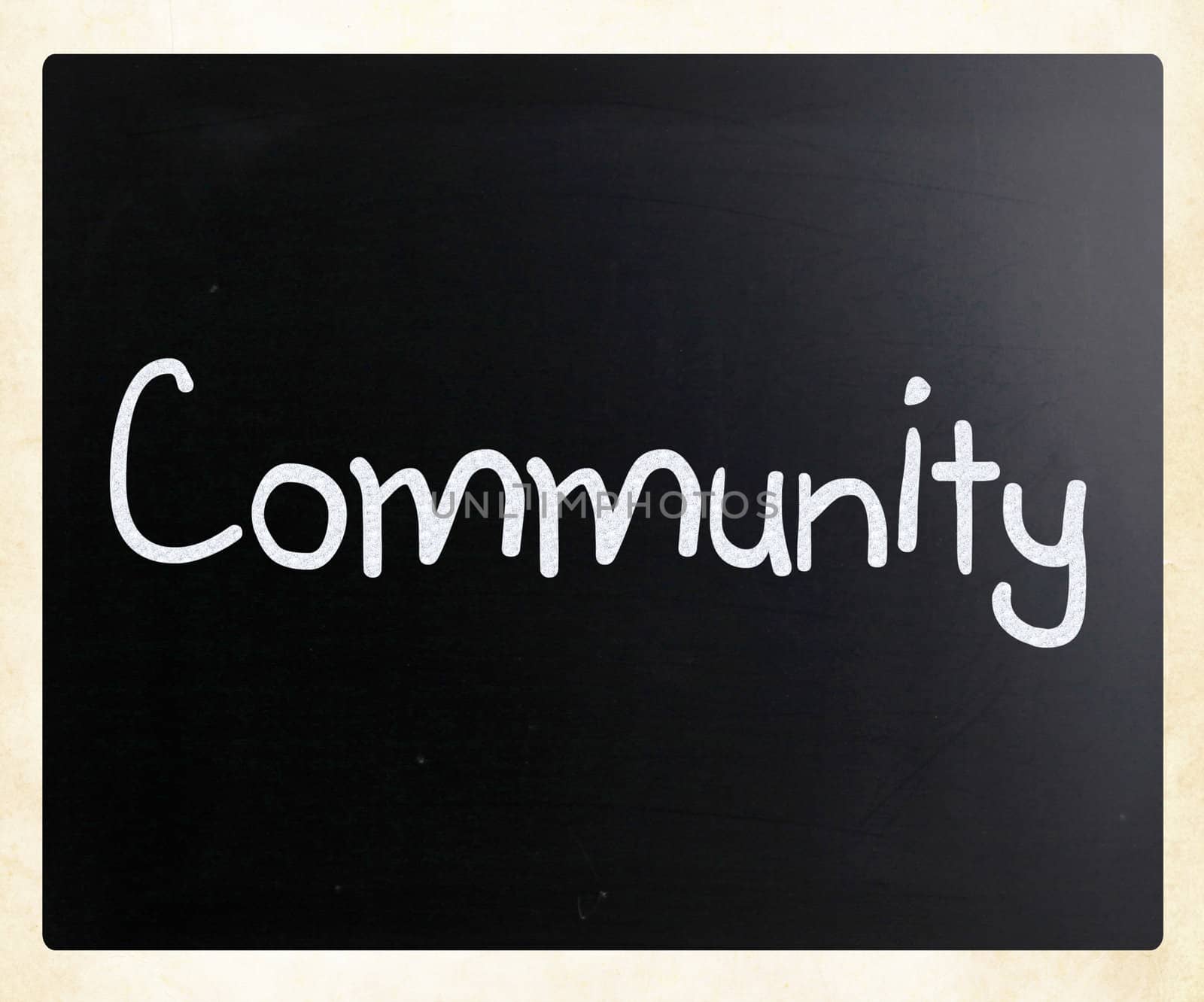 "Community" handwritten with white chalk on a blackboard