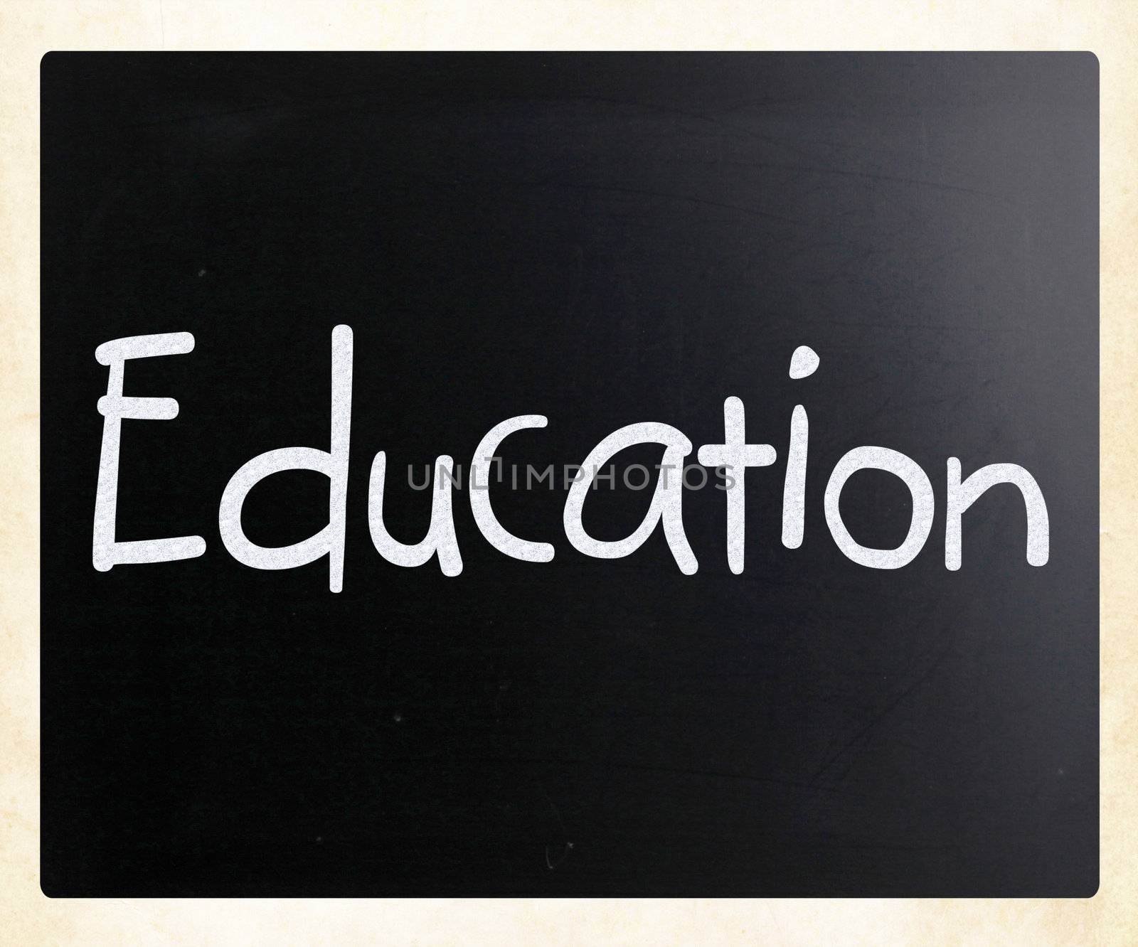The word "Education" handwritten with white chalk on a blackboard
