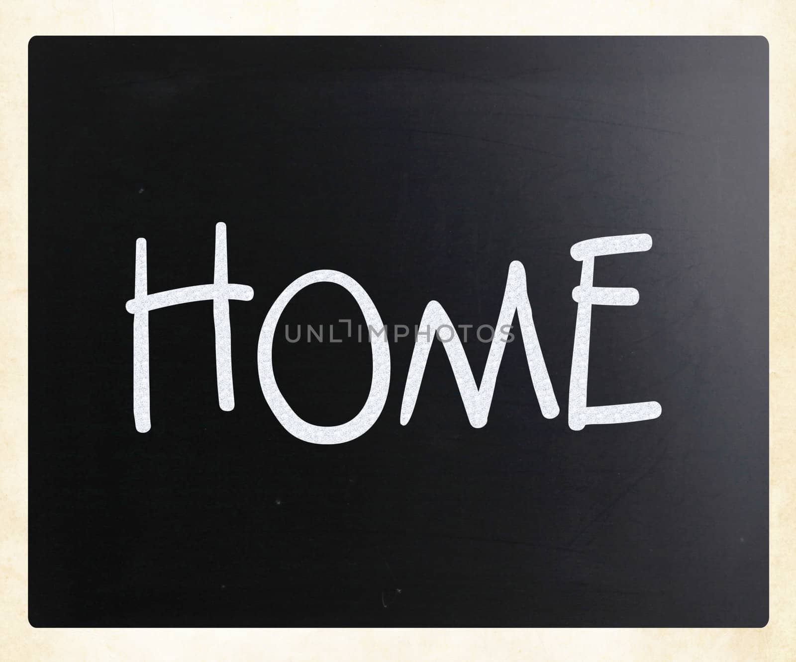 "Home" handwritten with white chalk on a blackboard