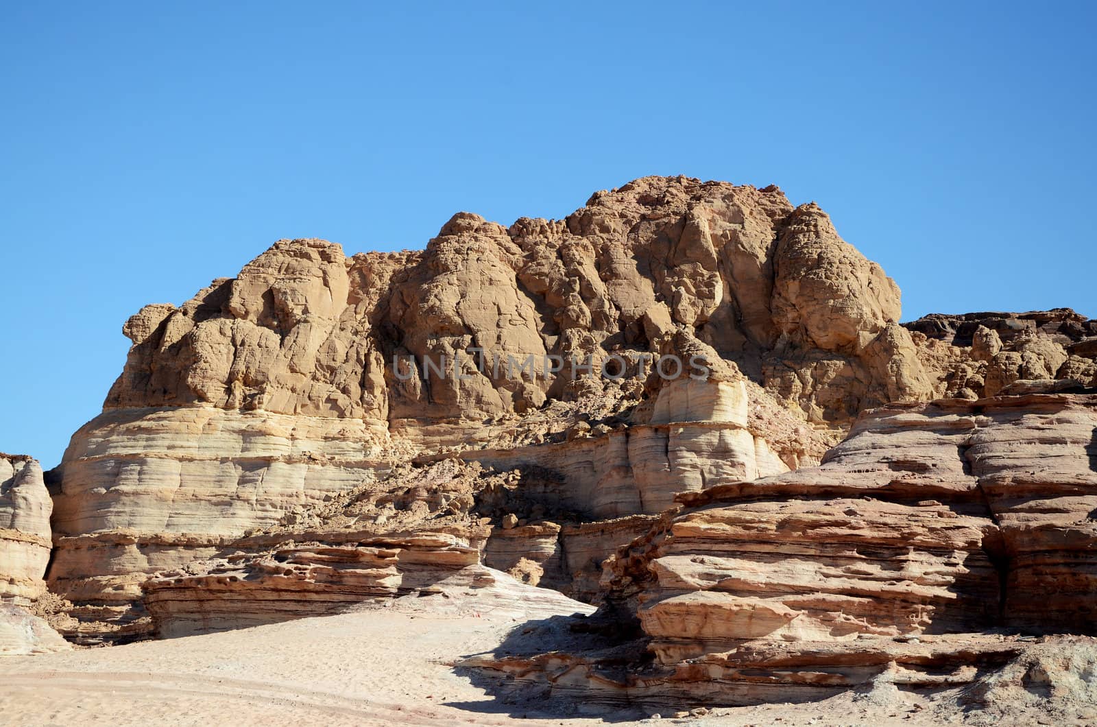 Rocky desert landscape under blue bright sky