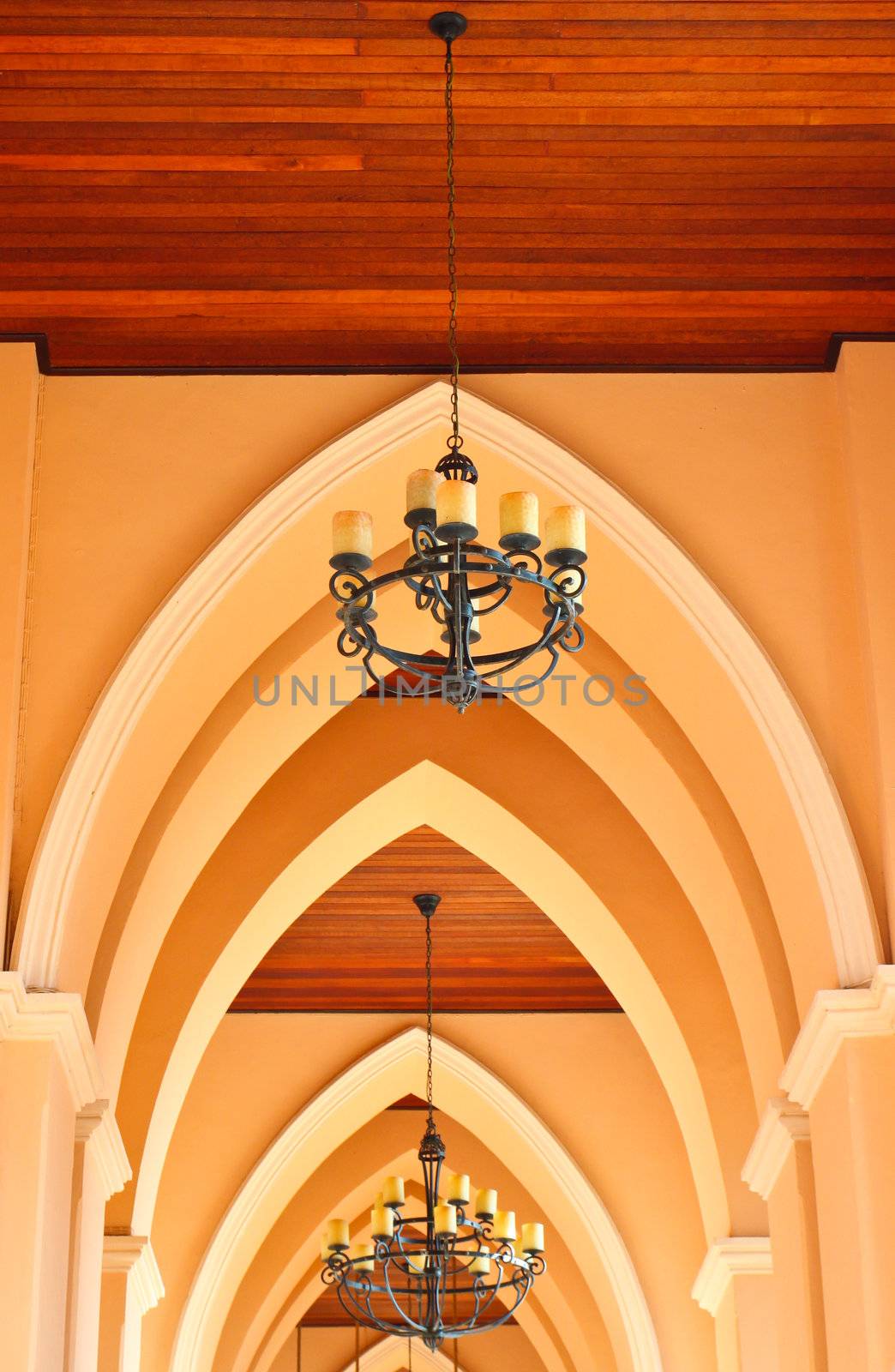 arched ceiling of church with chandelier by nuchylee