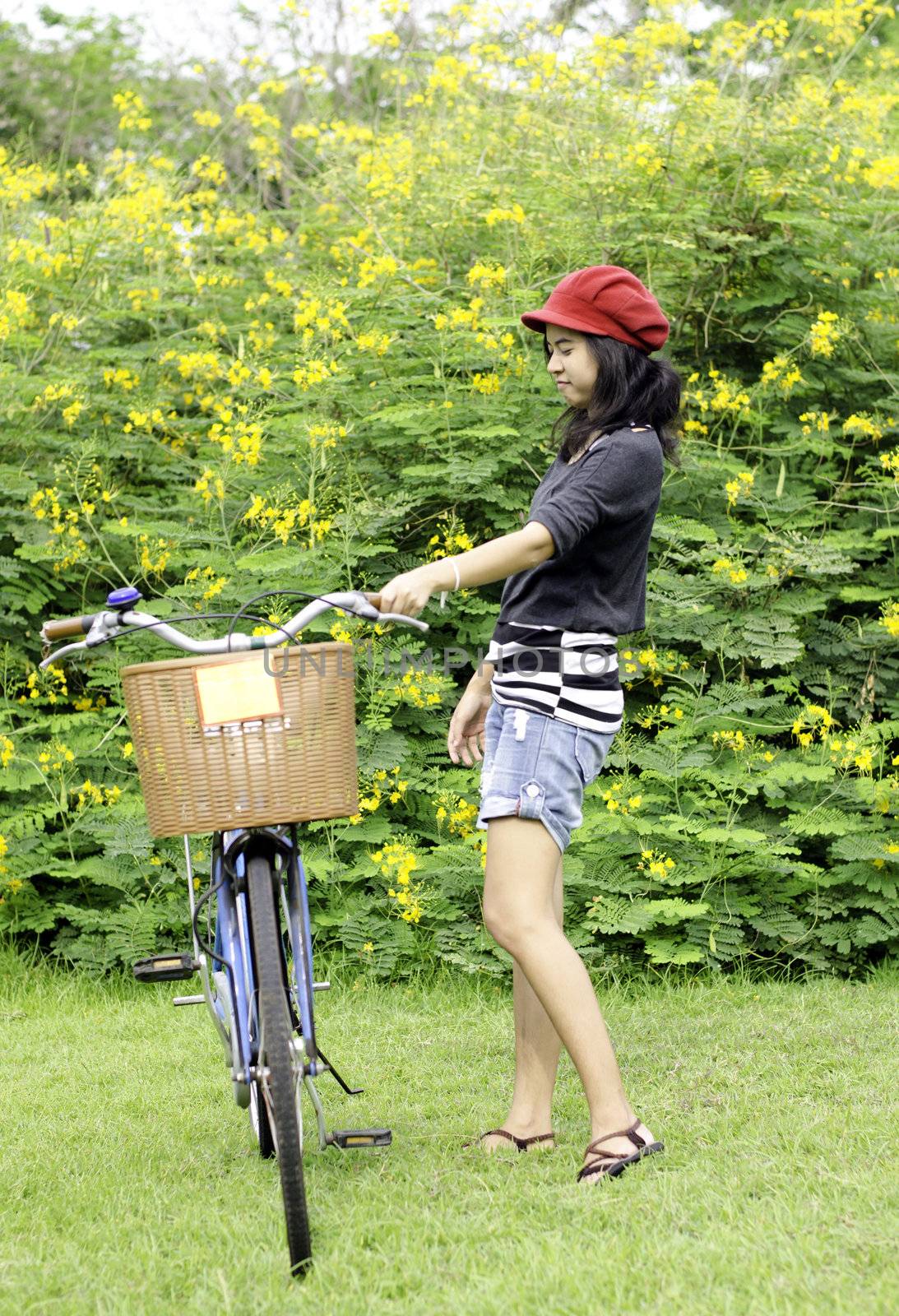 Young woman with retro bicycle in a park  by siraanamwong