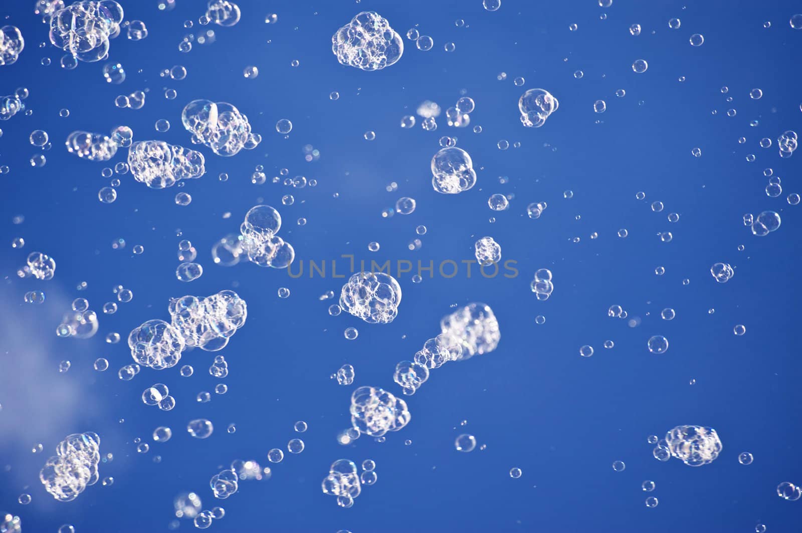 Soap bubbles before blue sky