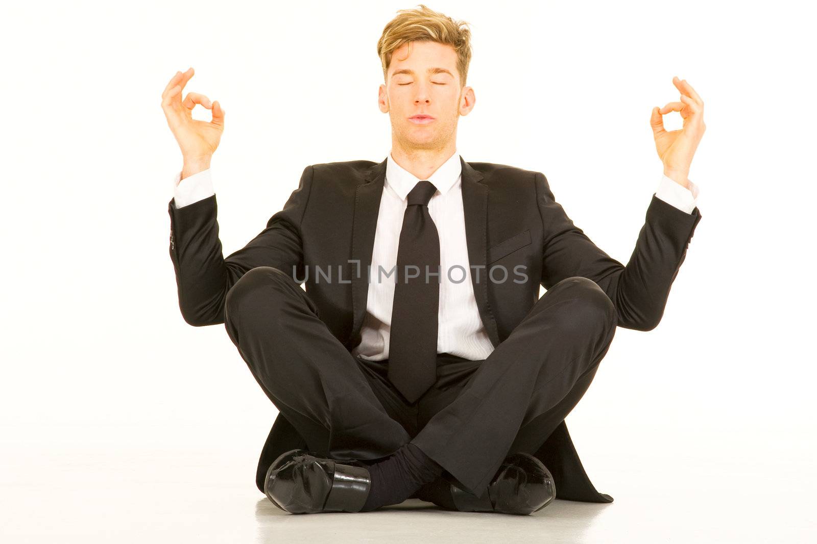 businessman doing yoga by ambro