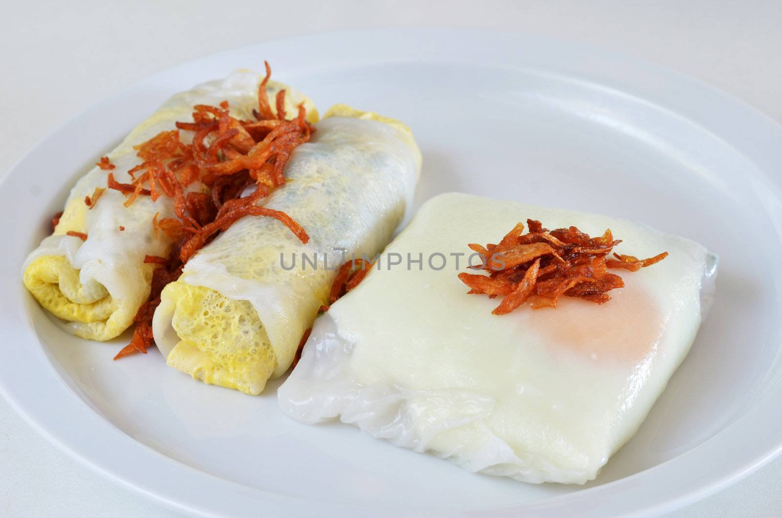 mixed vietnamese rice noodle rolls with a filling of pork sliced and egg ,  fried onion