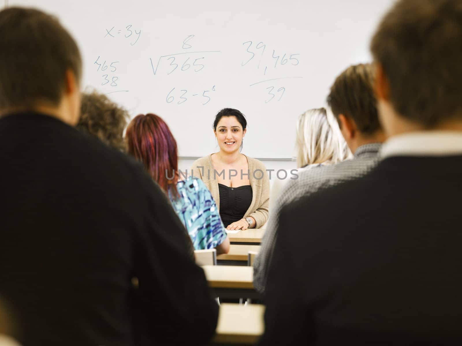 Teacher in classroom by gemenacom