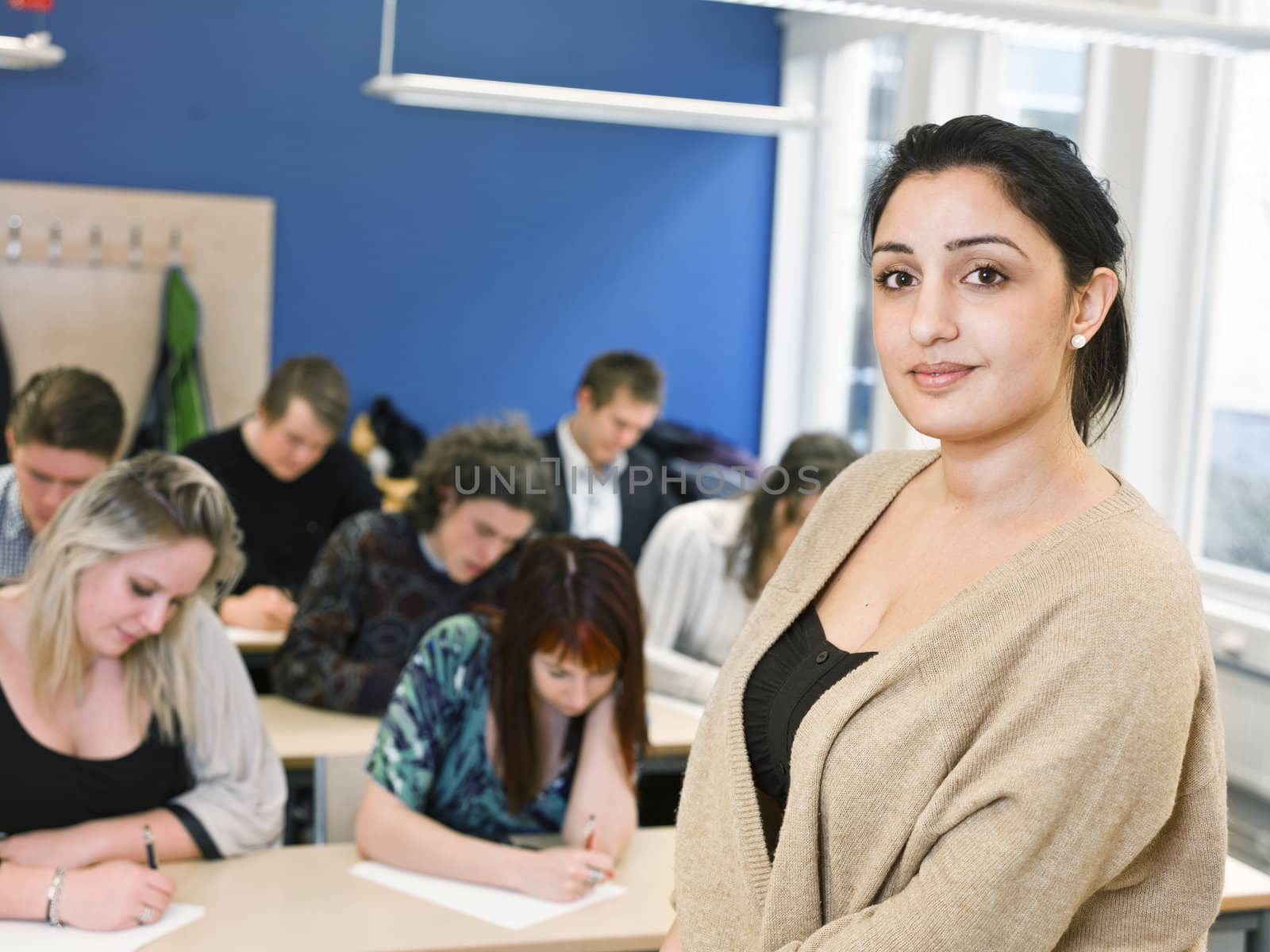 Schoolteacher in front of pupils in the classroom