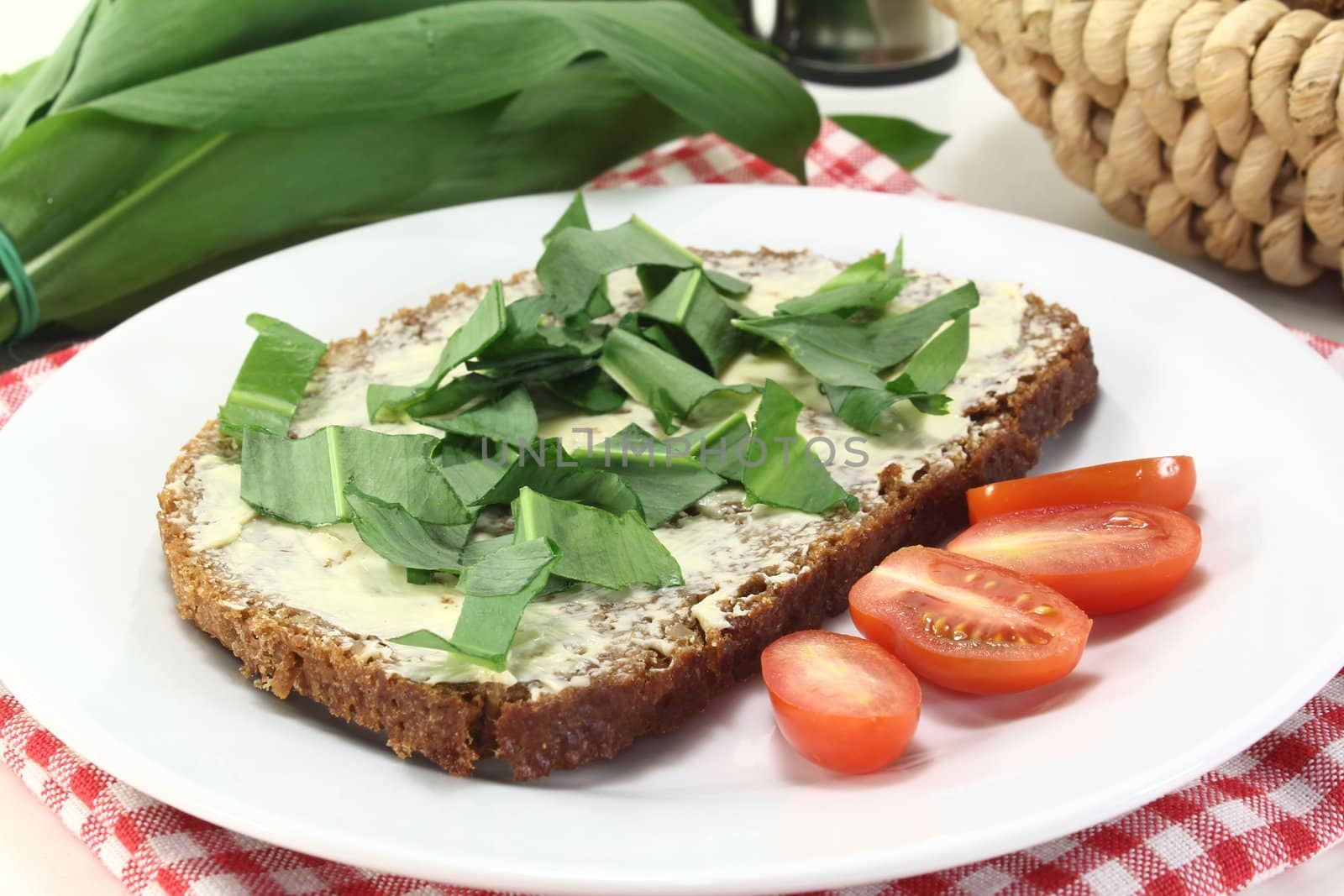 a slice of whole grain bread with butter and wild garlic