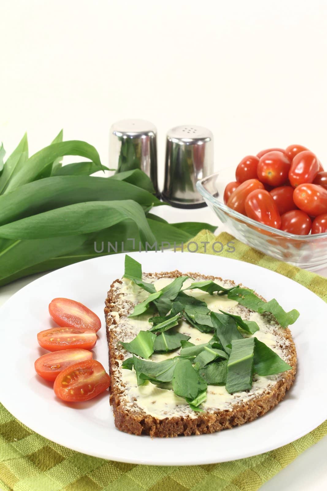 a slice of whole grain bread with butter and wild garlic