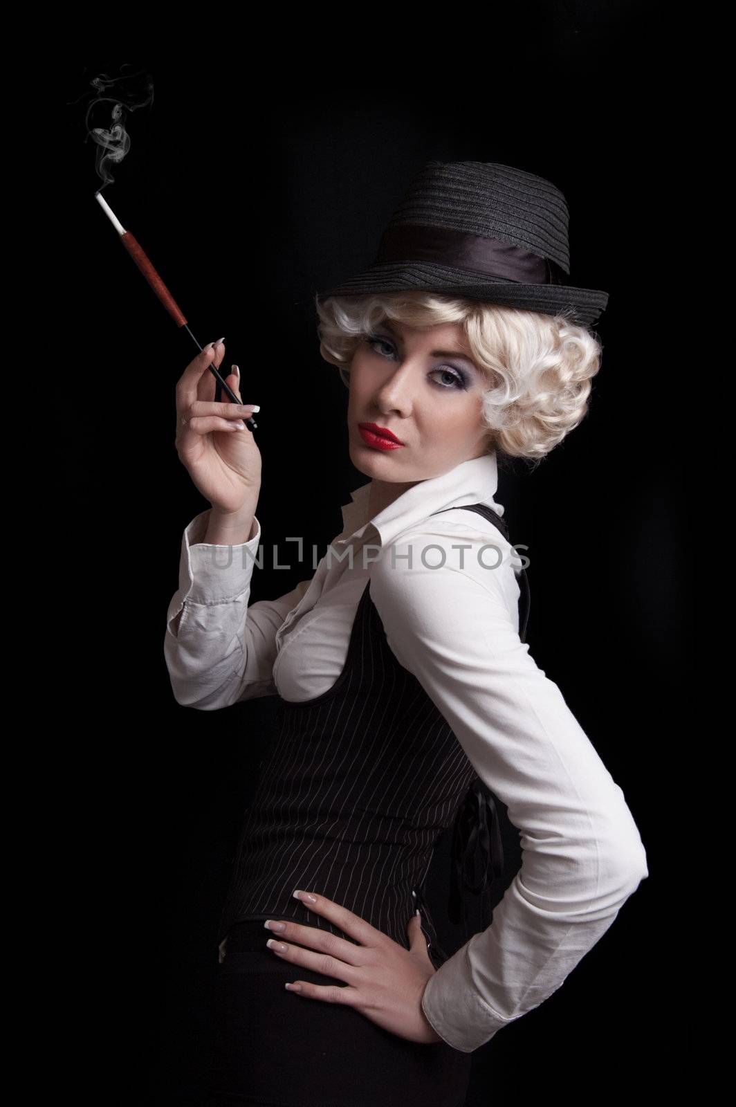 Elegant woman in corset and hat with cigarette over black