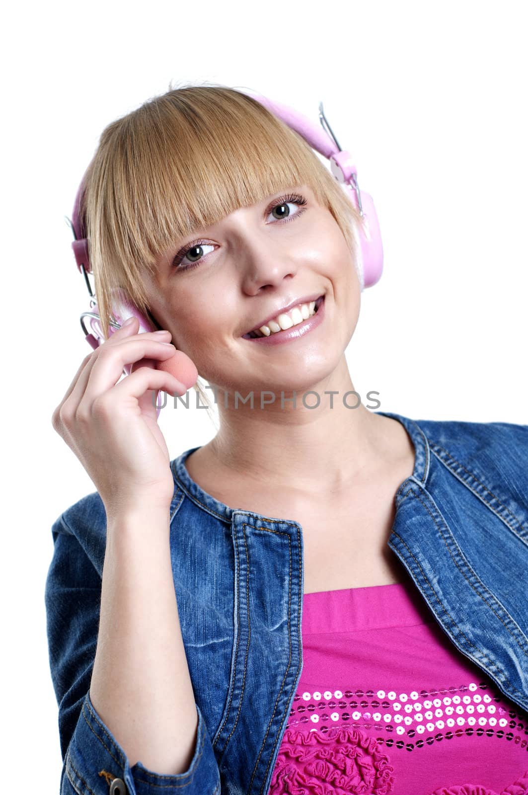 Young attractive woman listing to music with headphones against white background