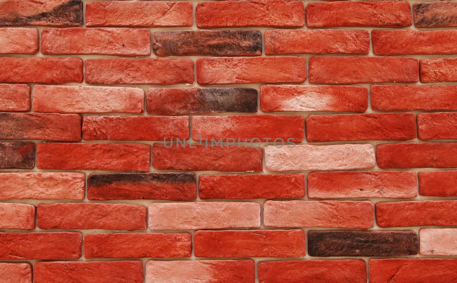 Red decorative bricks wall close-up as background