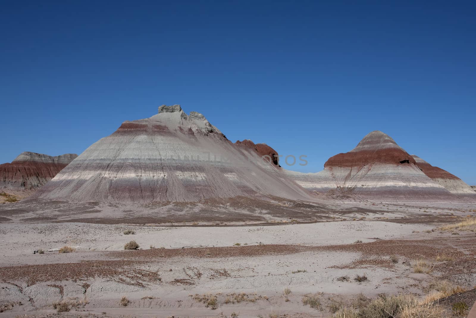 Dome shaped grey and reds against blue sky.