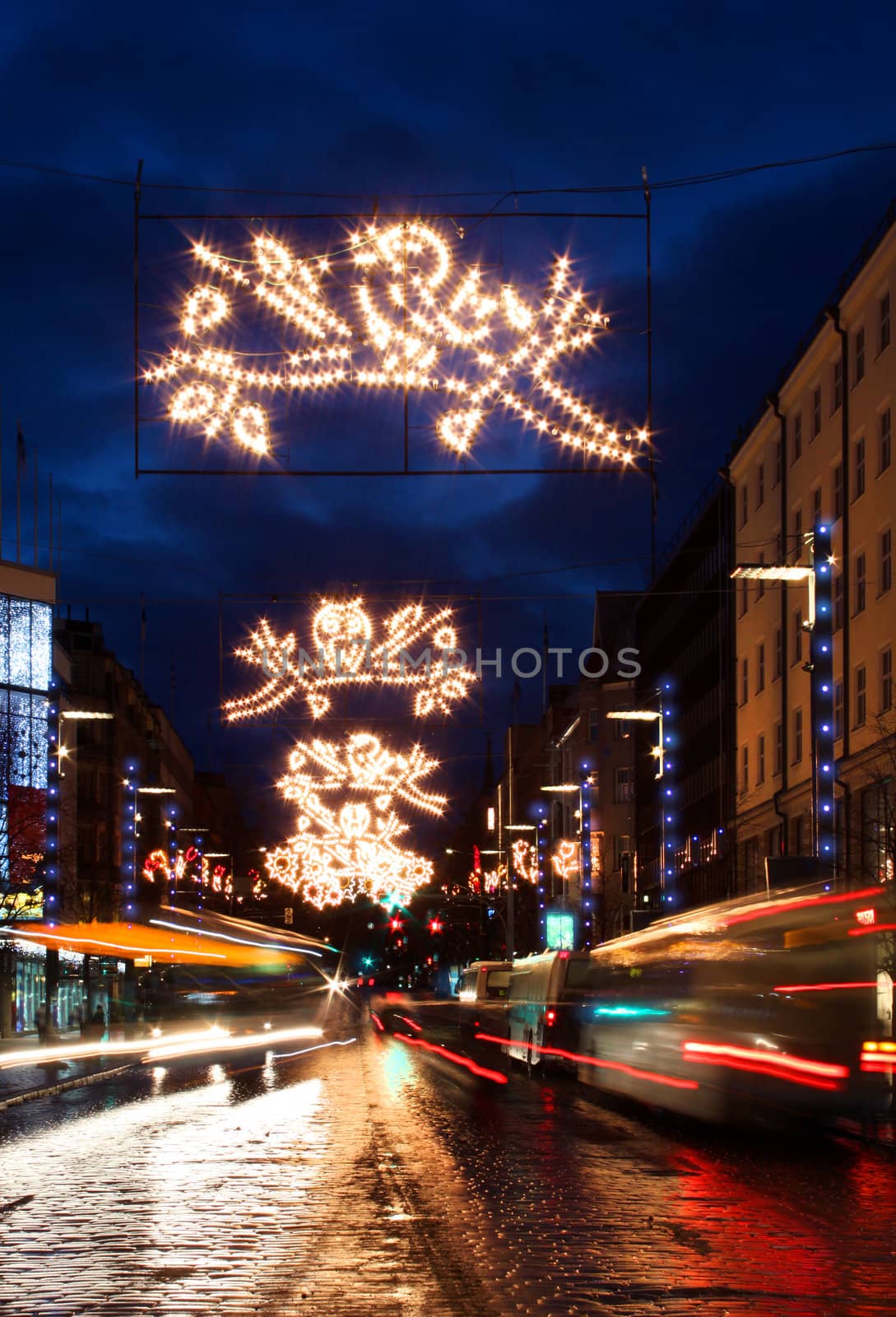 City street with Christmas light decoration and busy traffic