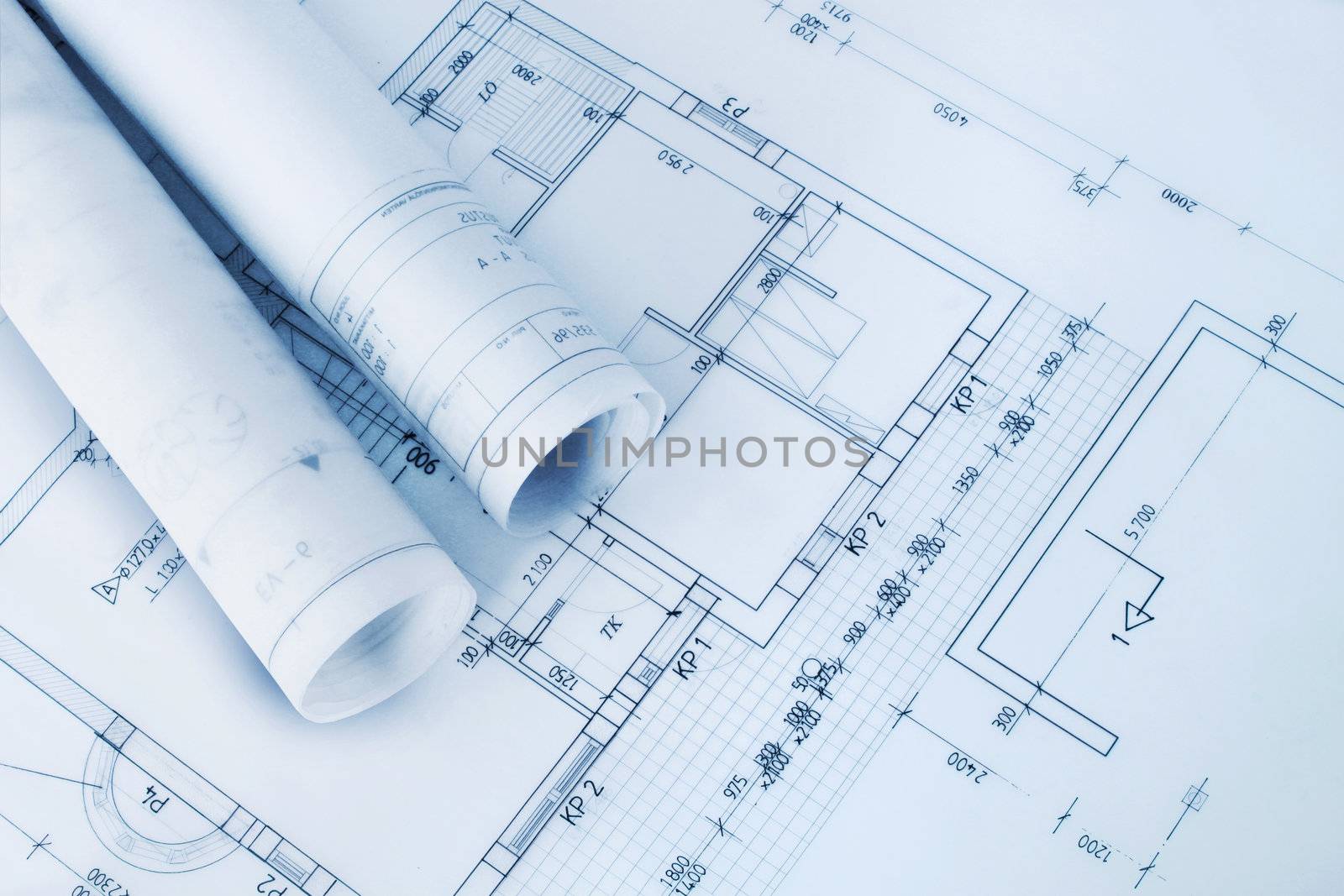 Construction plan blueprint rolls with drawings
