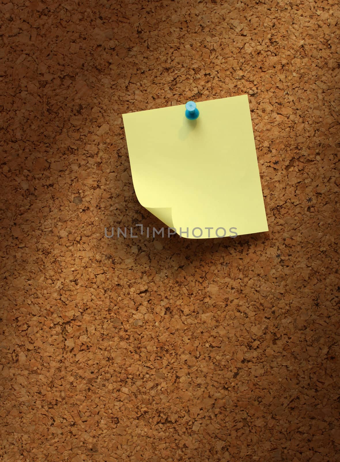 Empty yellow note paper on cork board shadow background