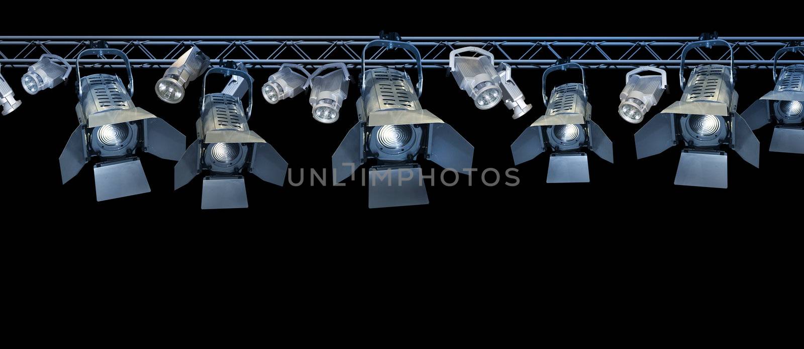Professional stage spotlight lamps rack on black background