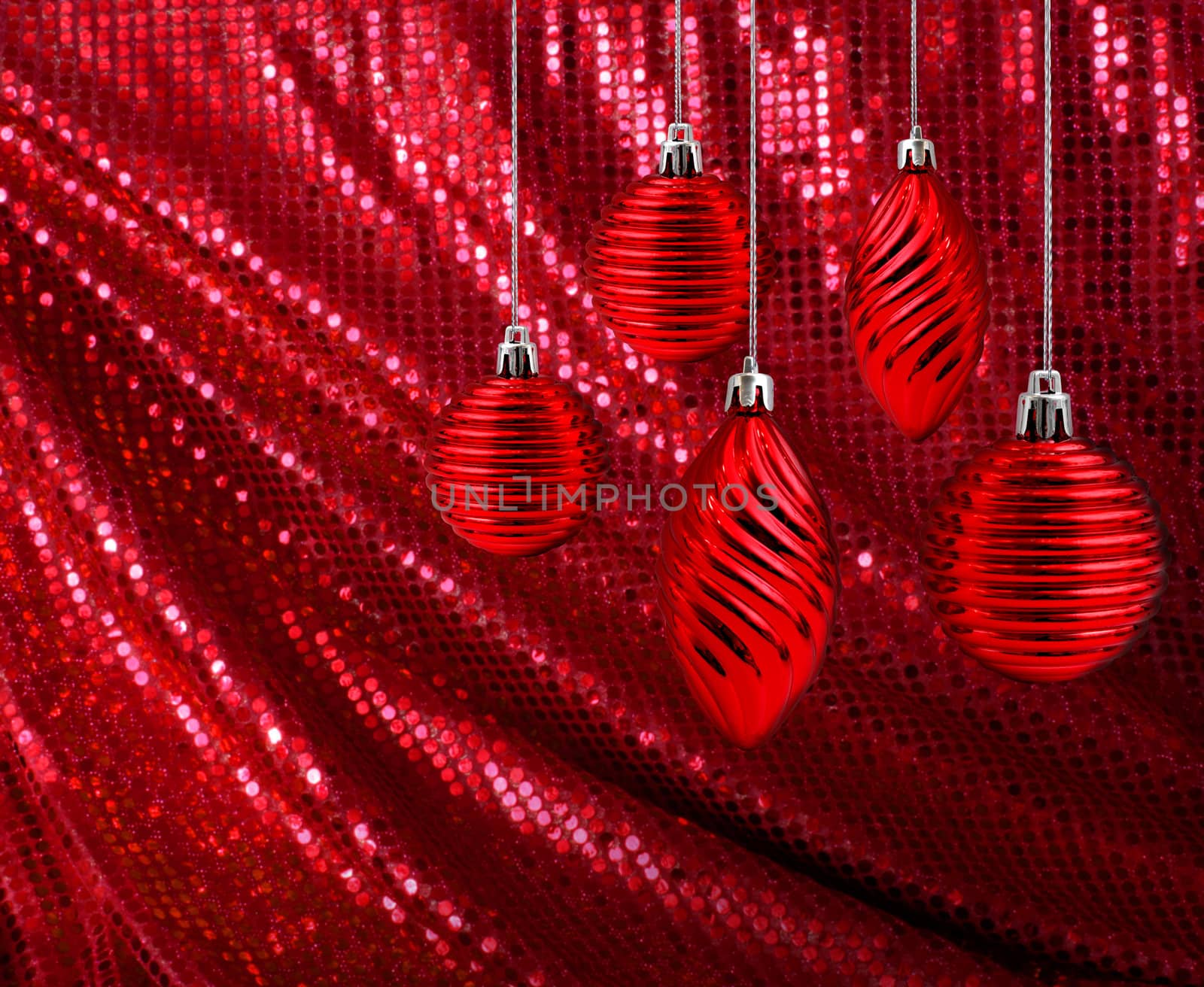 Red Christmas decoration balls and cones hanging on glitter canvas