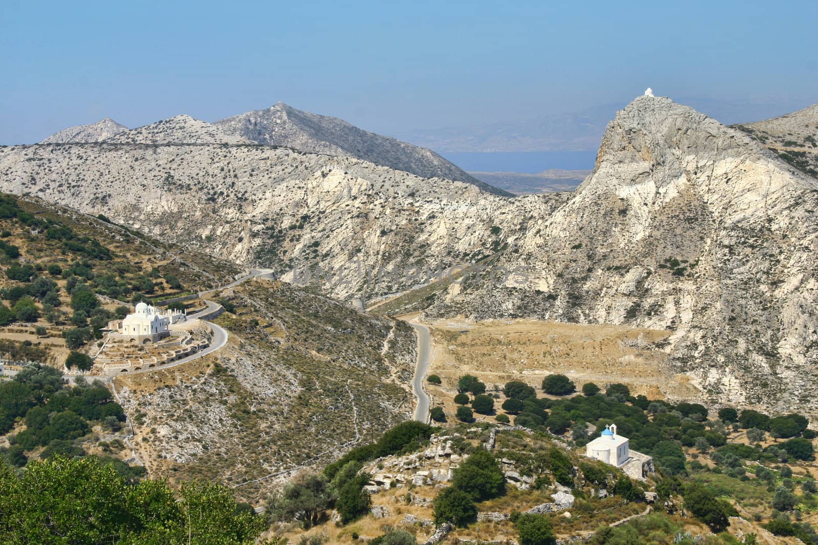 Three Greek mountain churches in same valley landscape