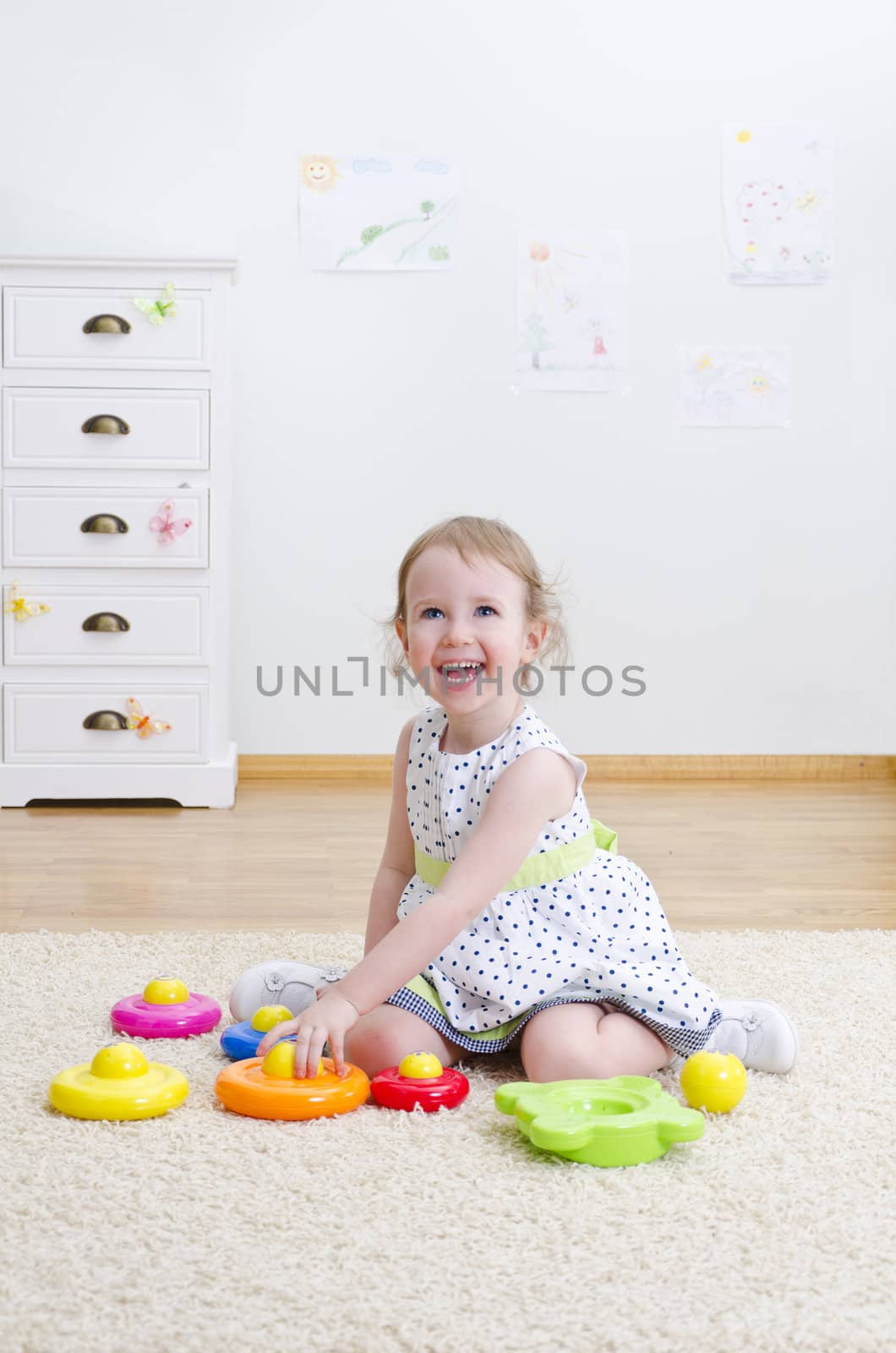 Little girl playing in a pyramid toy