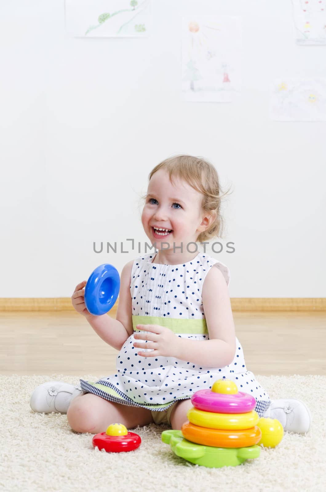 Little girl playing in a pyramid toy
