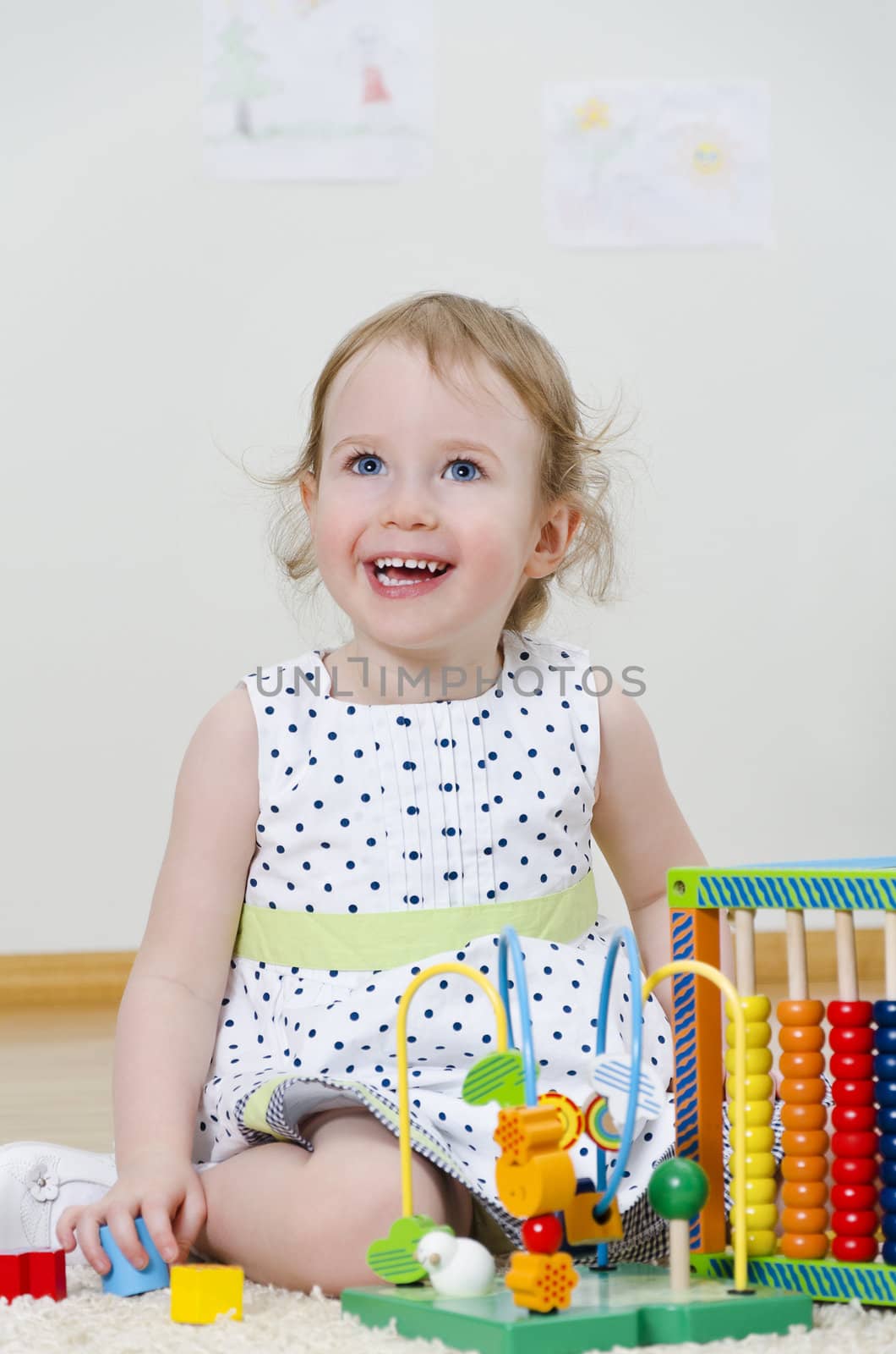 Little girl playing in a developing toy
