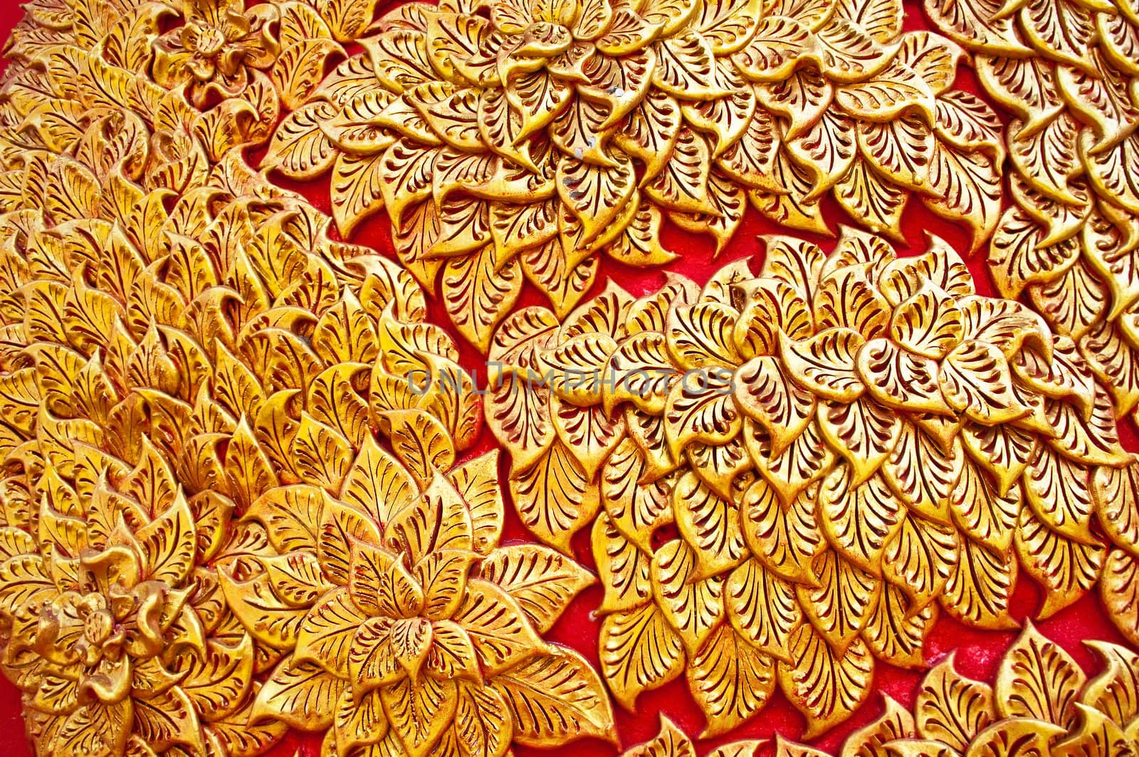 The gold stucco design of native thai style on the Wall