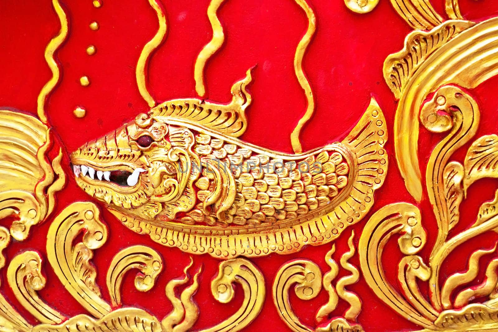 The gold stucco design of native thai style on the Wall