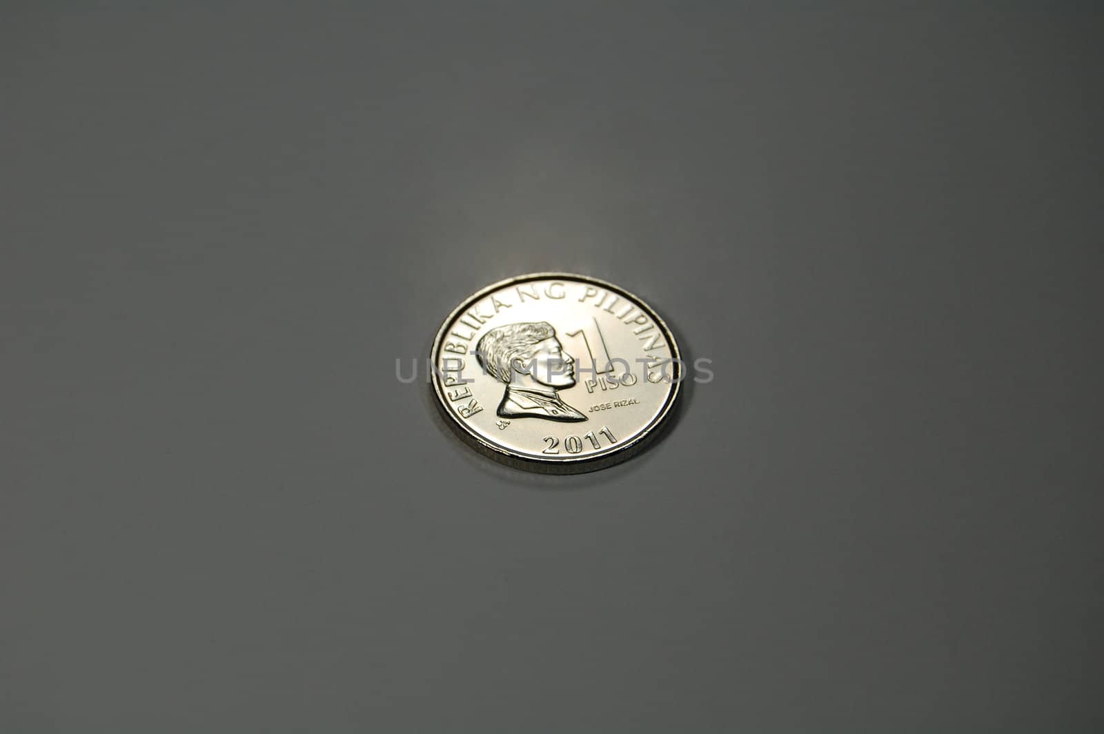 A shiny silvery 1-peso coin