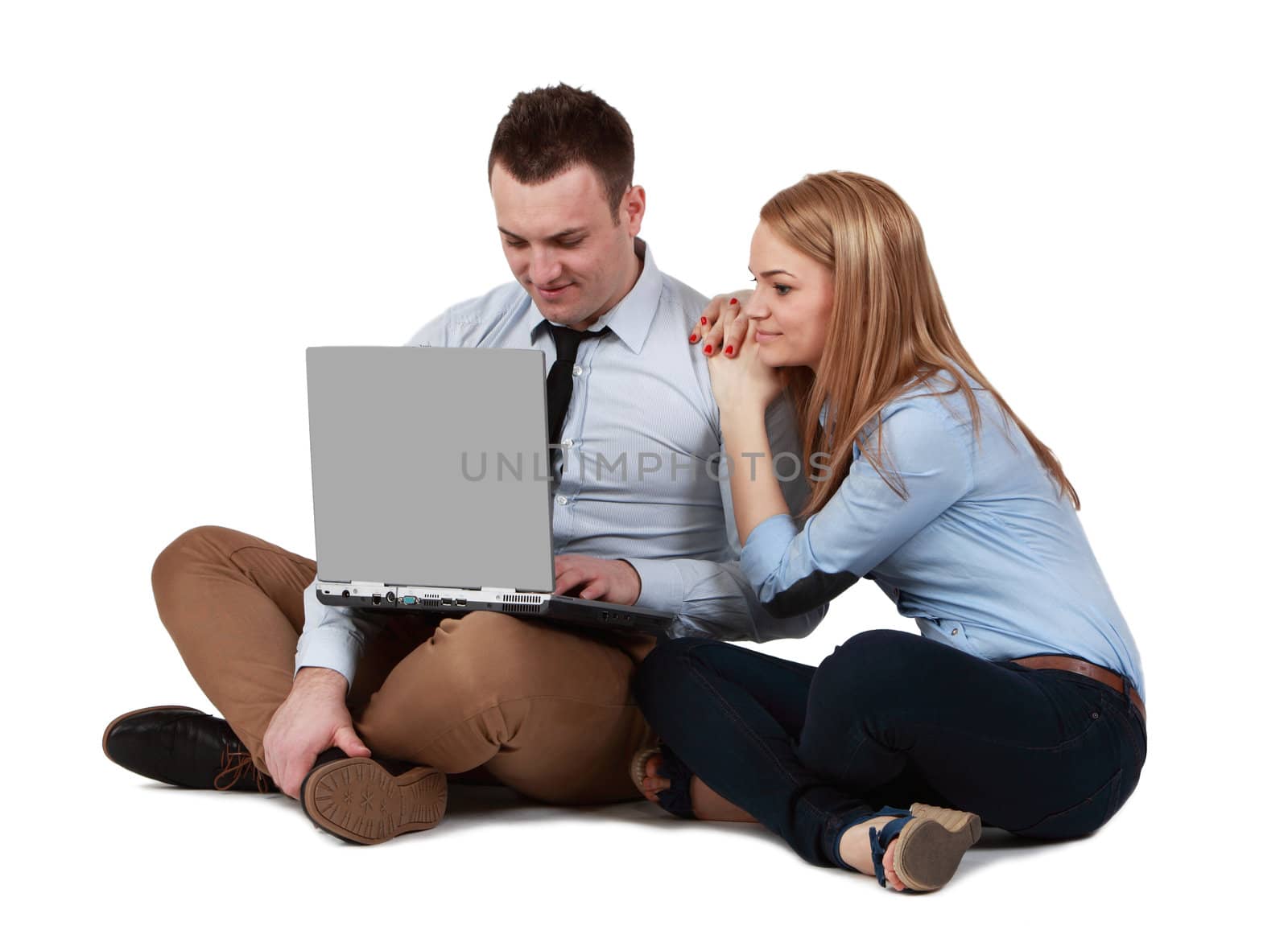 Young couple sitting together and working on a laptop 