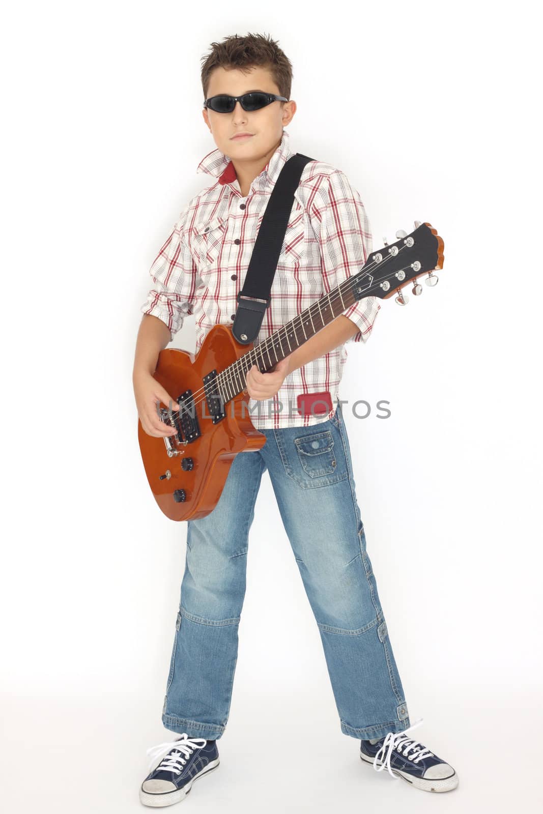 Boy playing with a guitar over white