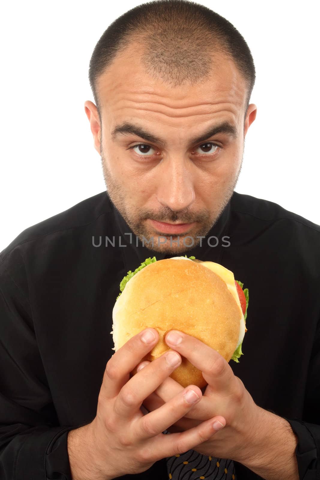 Young businessman eating hamburger over white