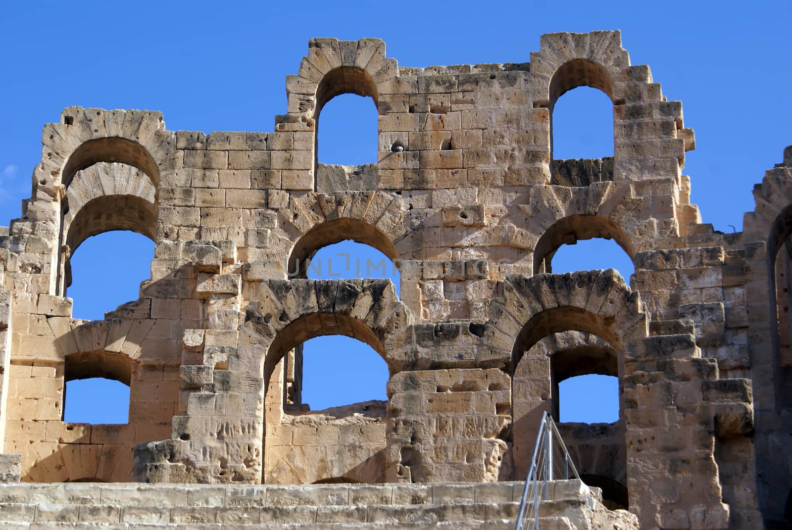 Wall of roman theater and blue sky in El-Jem, Tunisia         