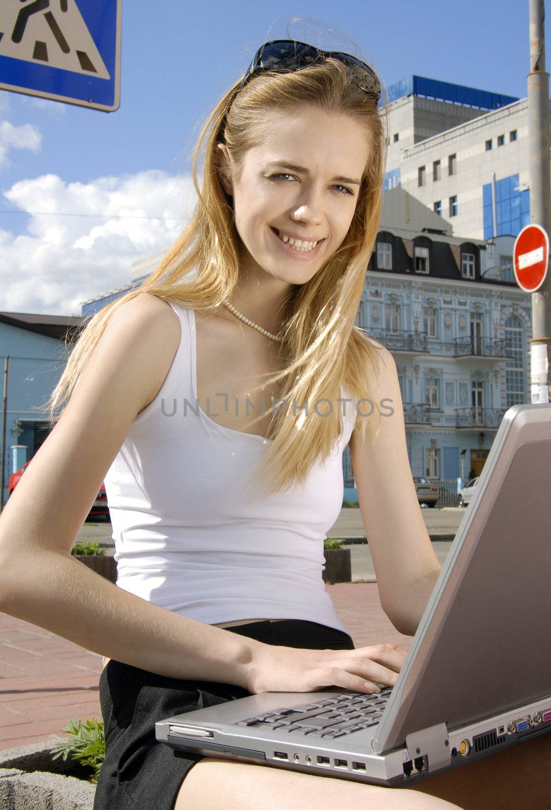 woman with laptop in a hi-tech urban surrounding by ssuaphoto