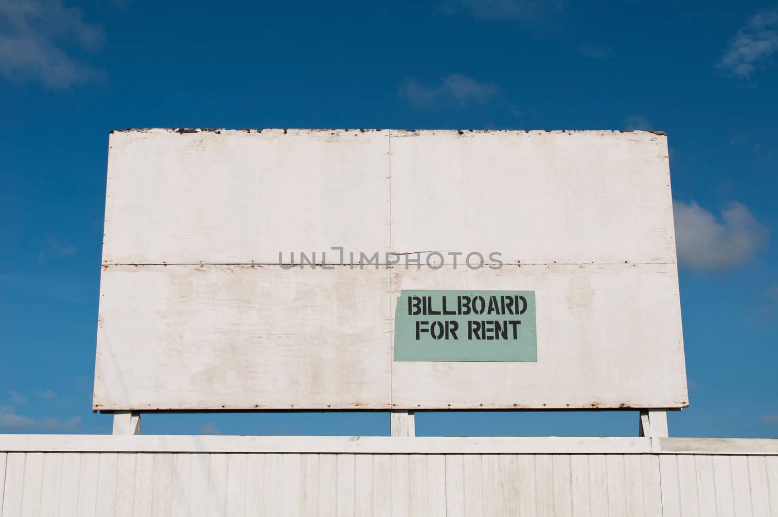 wooden billboard against a blue sky background