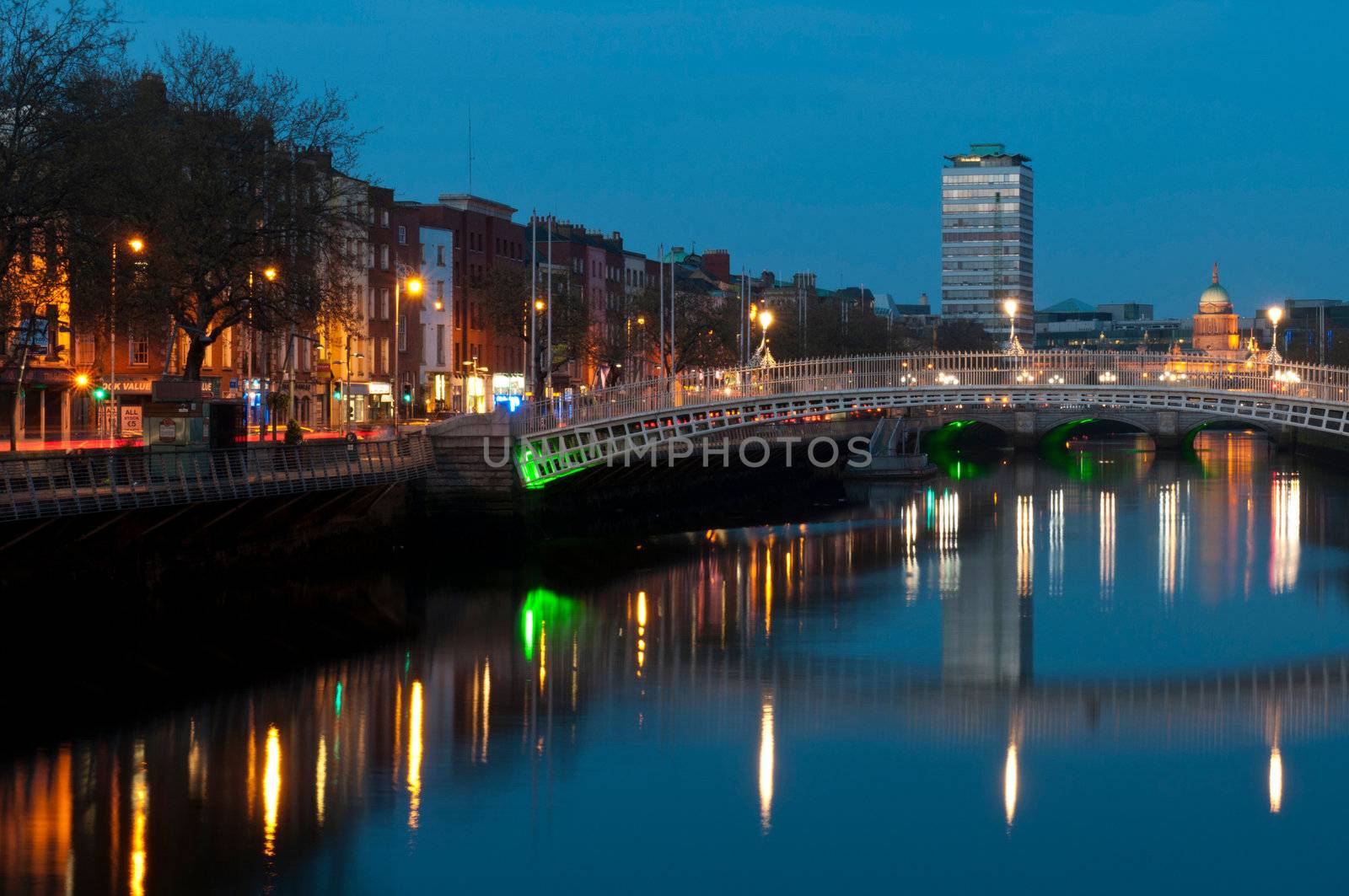 stunning nightscene with Ha'penny bridge and Liffey river, the Custom House landmark at the background (picture taken after sunset)