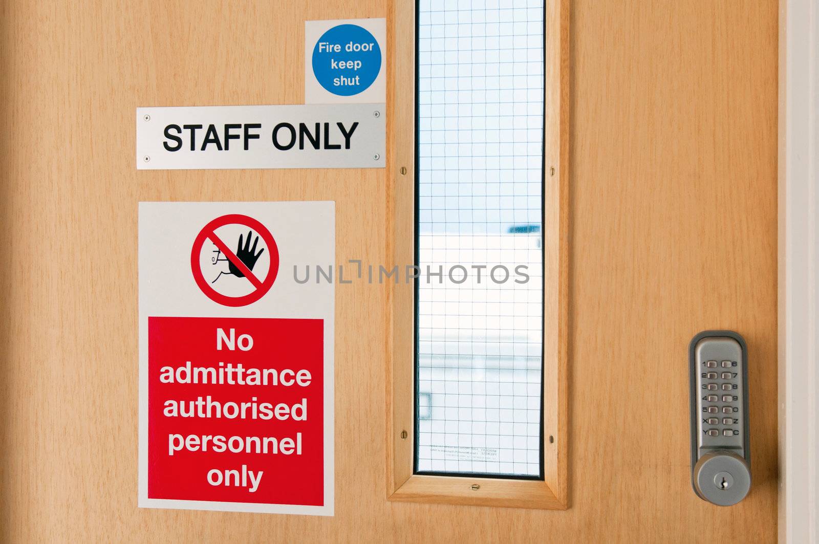 staff only door signs outside laboratory room with security door lock keypad