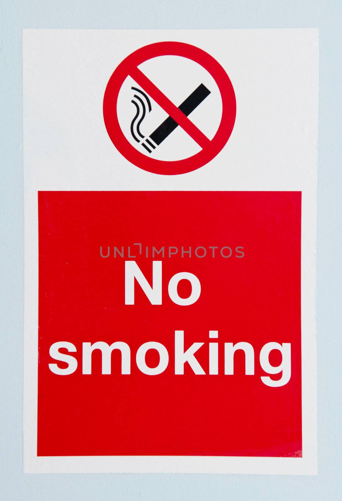 no smoking sign against a blue wall background