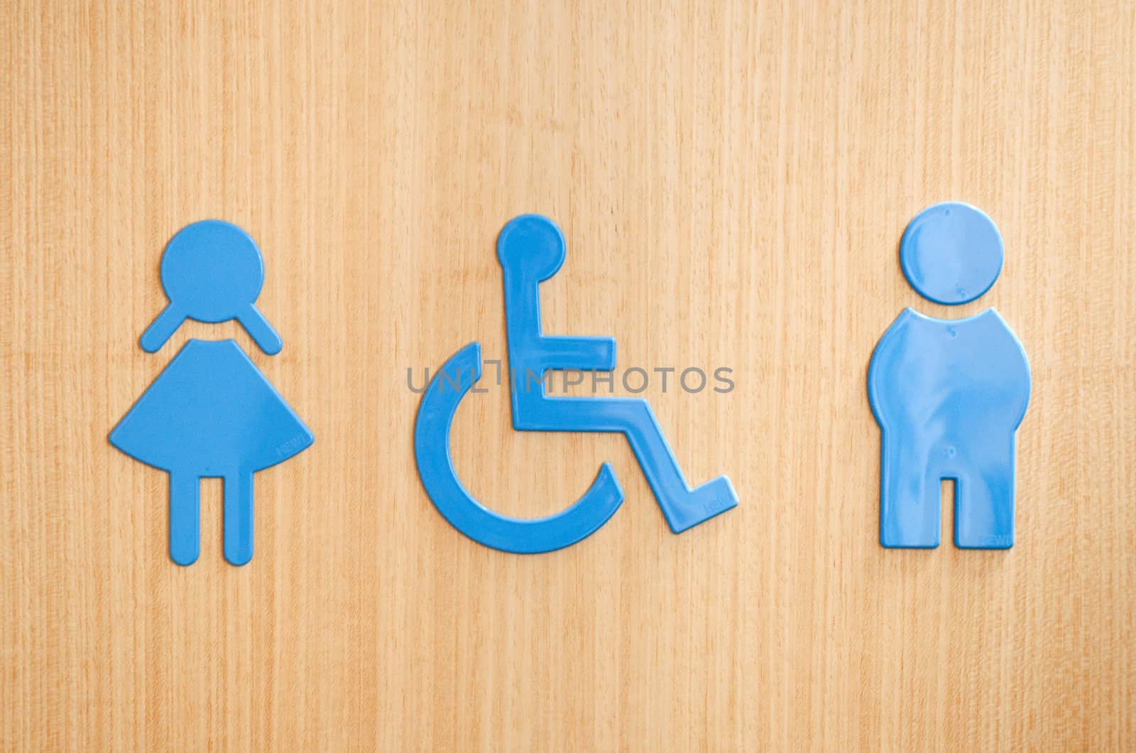 blue toilets WC sign for men, wheelchair and women (wooden background)